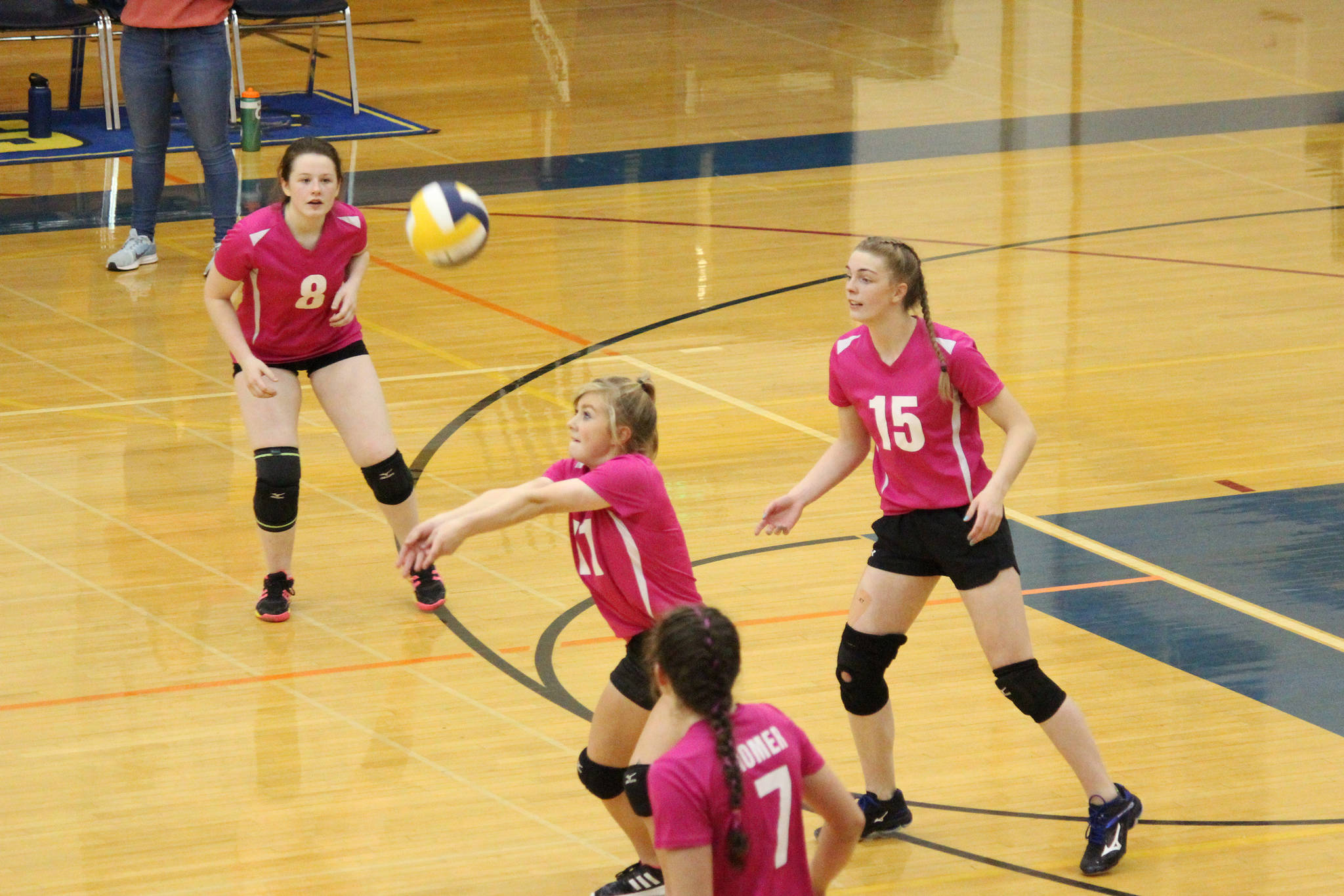 Sela Weisser digs a serve while her teammates prepare for their next move during their game against Soldotna High School on Tuesday, Oct. 9, 2018 at Homer High School in Homer, Alaska. (Photo by Megan Pacer/Homer News)
