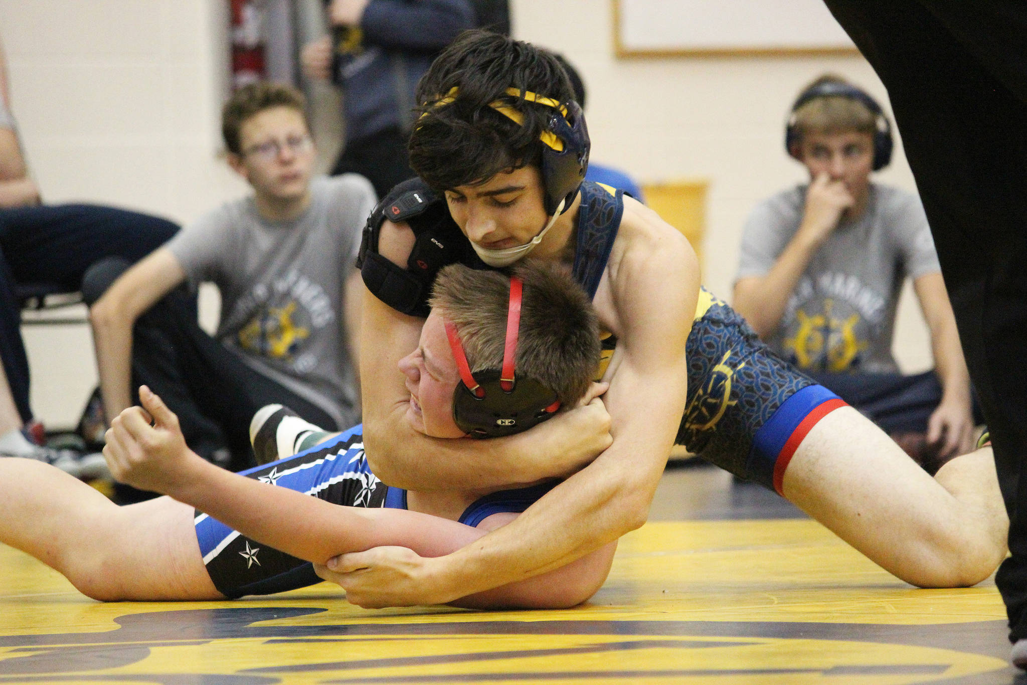 Homer’s David Weisser holds Soldotna’s Brian Kuhr in a head lock while they wrestle Friday, Oct. 19, 2018 at Homer High School in Homer, Alaska. (Photo by Megan Pacer/Homer News)