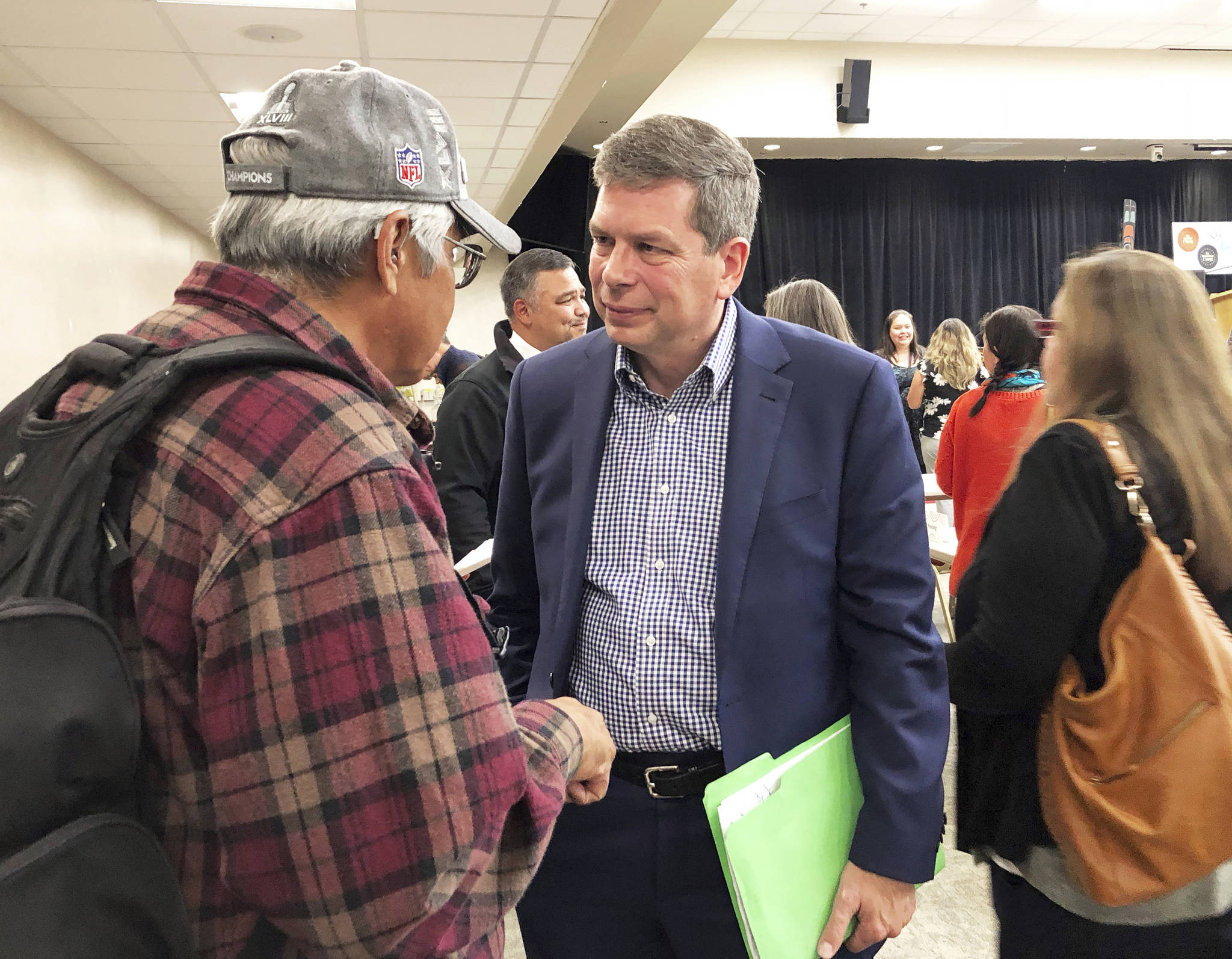 Democratic nominee for governor in Alaska Mark Begich, center, speaks to a man following a candidate forum on Tuesday, Oct. 2, 2018, in Juneau, Alaska. Also attending the forum were Gov. Bill Walker, an independent, and Libertarian Billy Toien. (AP Photo/Becky Bohrer)