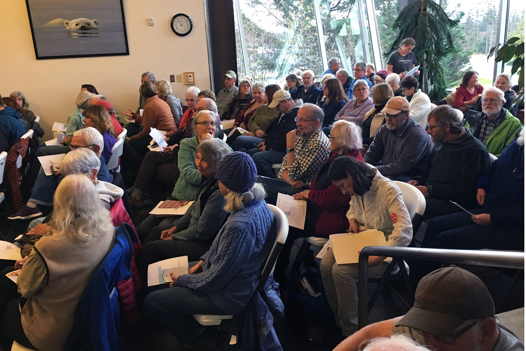 Area residents mingle and talk while waiting for a candidate forum to start Saturday, Oct. 20, 2018 at the Homer Public Library in Homer, Alaska. The two candidates for the Alaska House of Representatives District 31 seat, Rep. Paul Seaton and Sarah Vance, responded to questions from the audience. (Photo by Megan Pacer/Homer News)