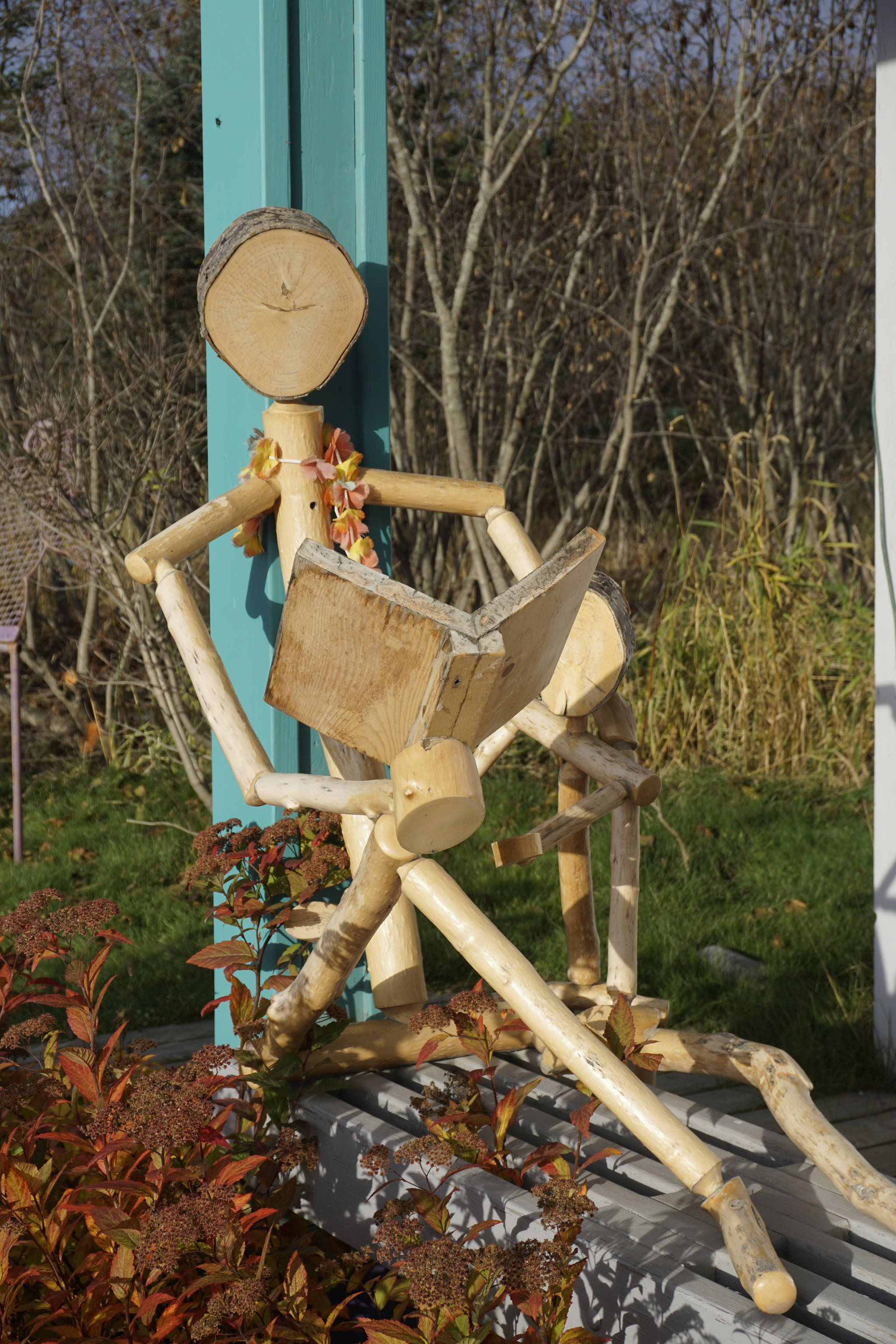 A stick man sculpture sits on the front porch of the Homer Bookstore on Oct. 29, 2018, in Homer, Alaska. (Photo by Michael Armstrong/Homer News)