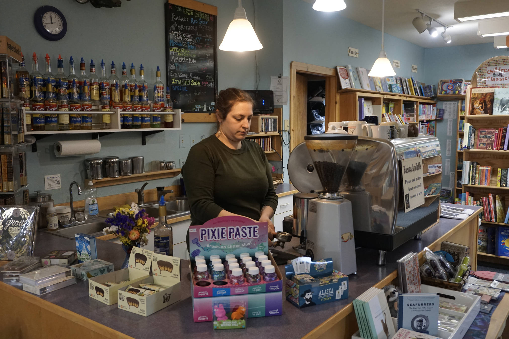 Jennifer Norton makes a latte at the Homer Bookstore’s coffee stand on Oct. 29, 2018, in Homer, Alaska. (Photo by Michael Armstrong/Homer News).
