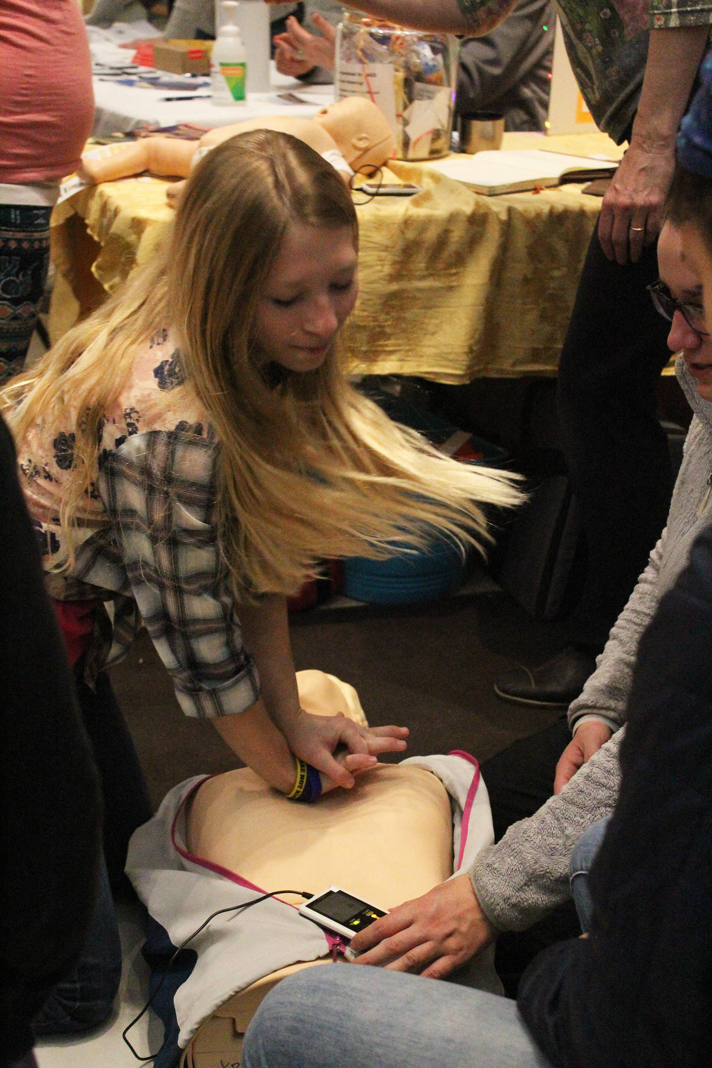 Maddox Berg, 14, practices performing CPR with the help of Homer Volunteer Fire Department’s Donna McNulty during the annual Rotary Health Fair on Saturday, Nov. 3, 2018 at Homer High School in Homer, Alaska. (Photo by Megan Pacer/Homer News)