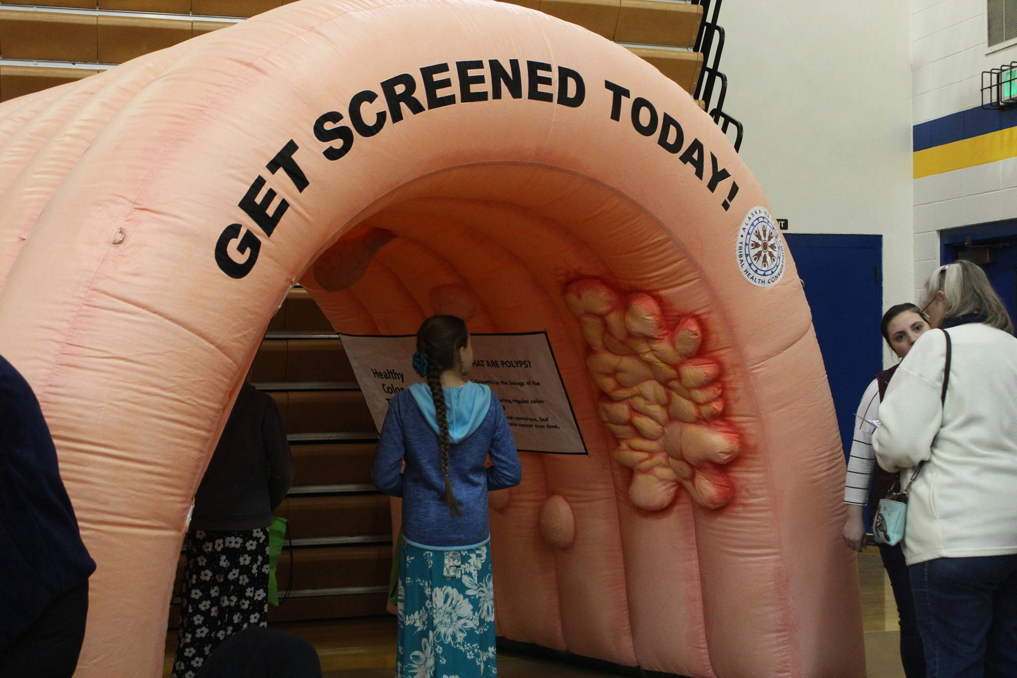 Fairgoers investigate “Nolan the Colon,” an inflatable tunnel used to teach colon health, at this year’s Rotary Health Fair on Saturday, Nov. 3, 2018 at Homer High School in Homer, Alaska. (Photo by Megan Pacer/Homer News)