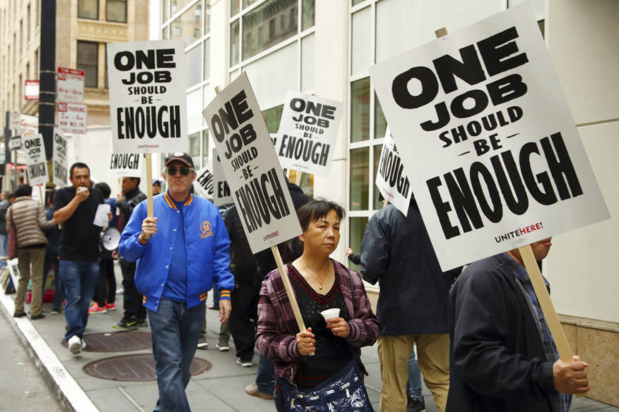 Hotel workers strike for a wage increase in front of a Marriott hotel Thursday, Oct. 4, 2018, in San Francisco. Alaska’s minimum wage is set to rise to $9.89 per hour on Jan. 1. (Ben Margot | The Associated Press)