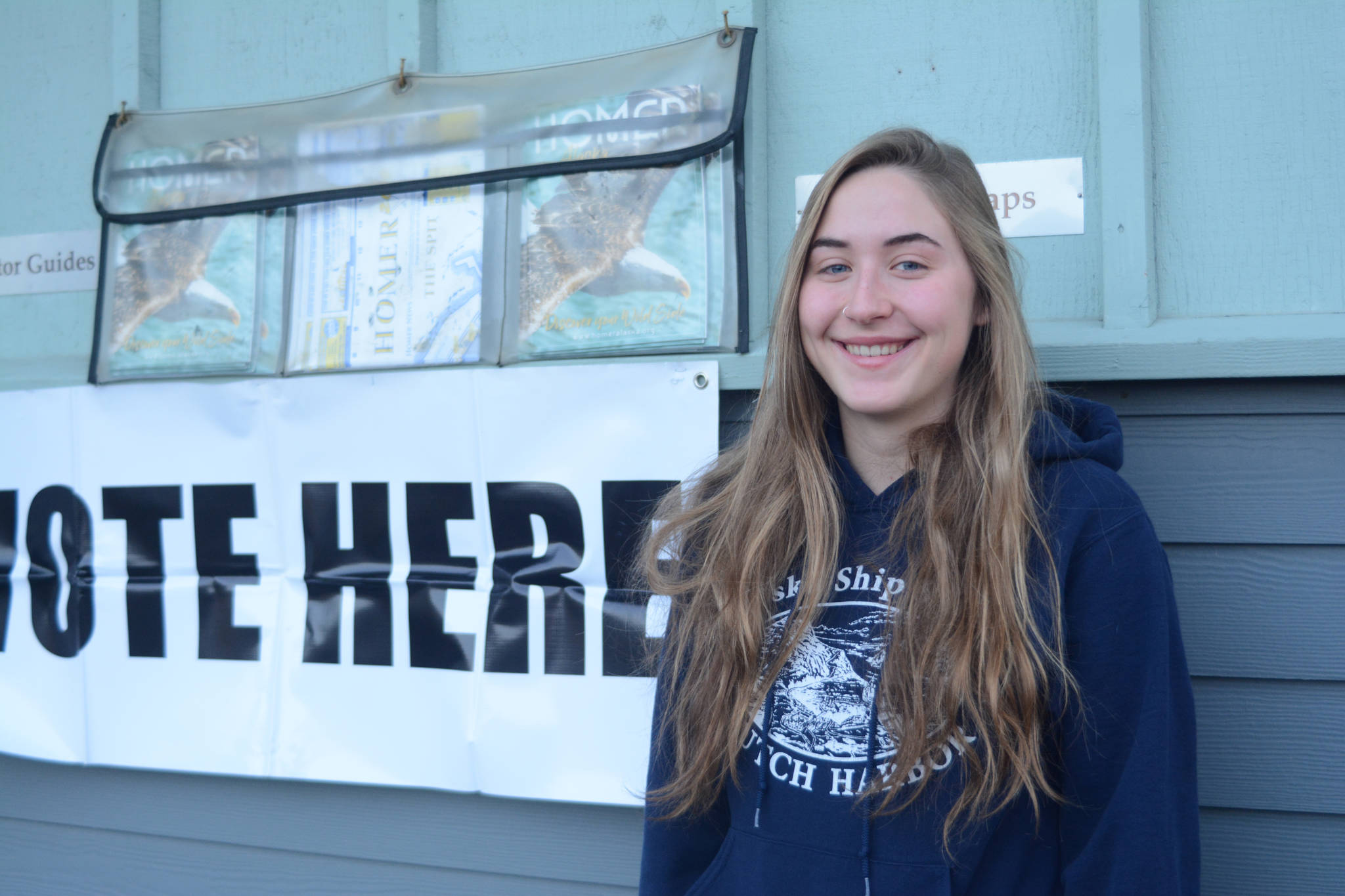 After voting in her first ever election, Brenna McCarron, 18, poses for a photo outside the Diamond Ridge Precinct at the Homer Chamber of Commerce and Visitor Center on Nov. 6, 2018, in Homer, Alaska. McCarron went to the polls with her father, Jim McCarron, who has been voting for 36 years. Her twin sister, Ali, also voted for the first time. They are both Homer High School seniors. (Photo by Michael Armstrong/Homer News)