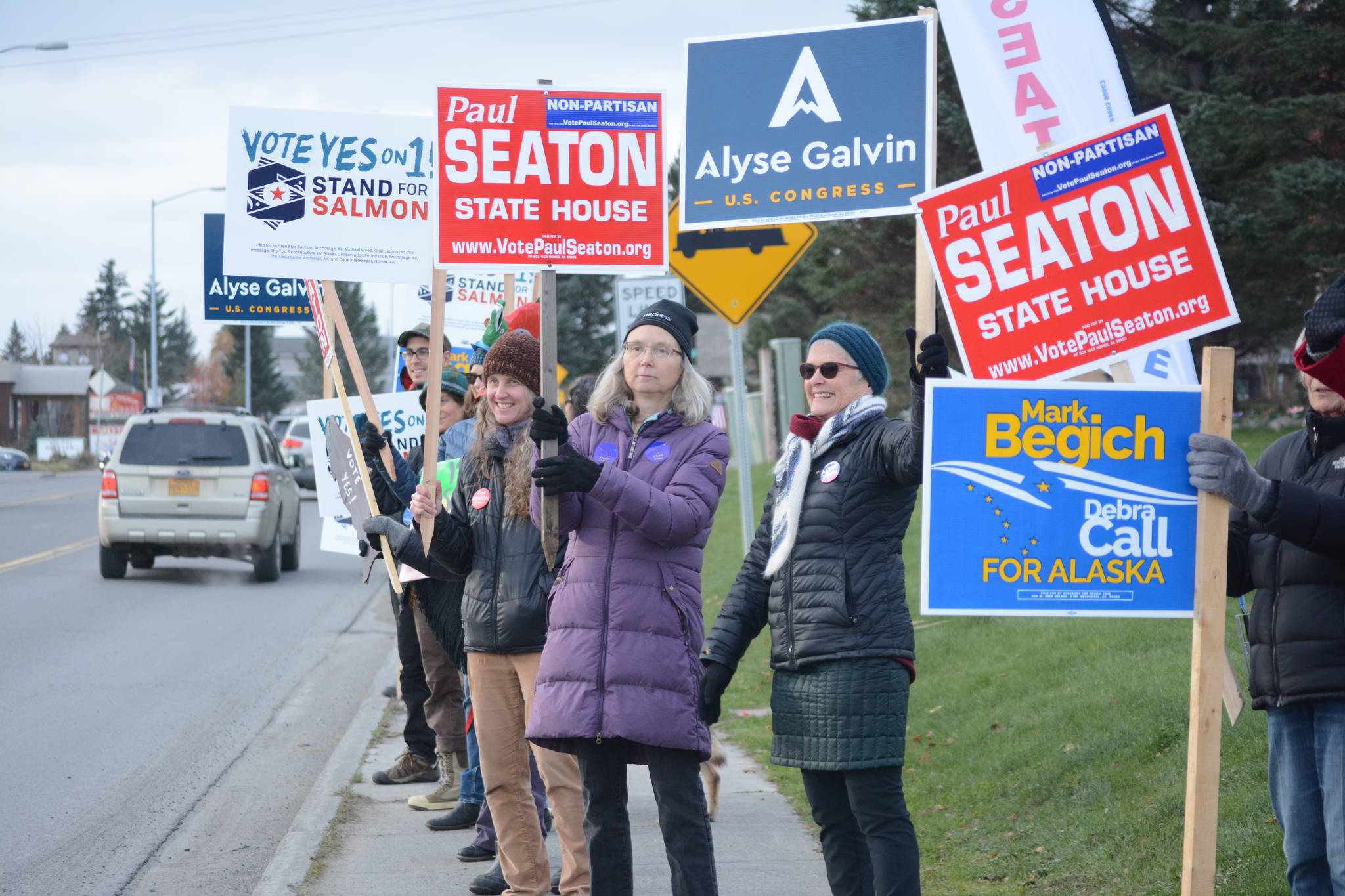 Democratic Party supporters wave signs in support of Paul Seaton, Mark Begich, Alyse Galvin and Yes on Ballot Measure 1. They were at the corner of Lake Street and Pioneer Avenue about 12:30 p.m. Nov. 6, 2018, in Homer, Alaska. (Photo by Michael Armstrong/Homer News0
