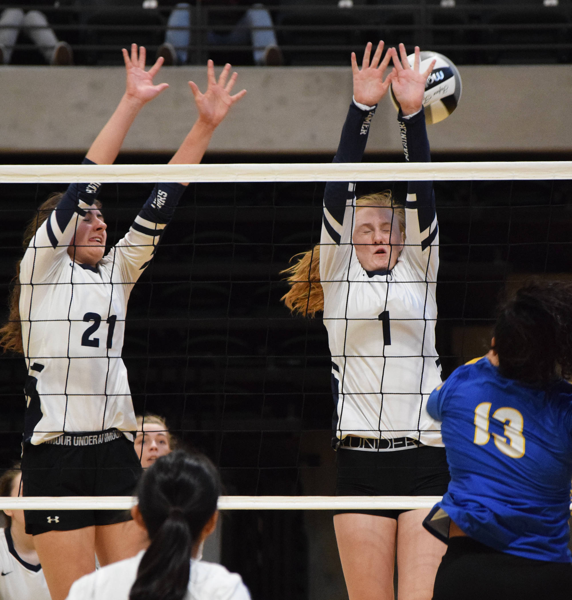 Homer’s Marina Carroll (21) and Kelli Bishop (1) team up for a block against the Barrow Whalers Friday, Nov. 9, 2018 at the Class 3A state volleyball tournament at the Alaska Airlines Center in Anchorage, Alaska. (Photo by Joey Klecka/Peninsula Clarion)