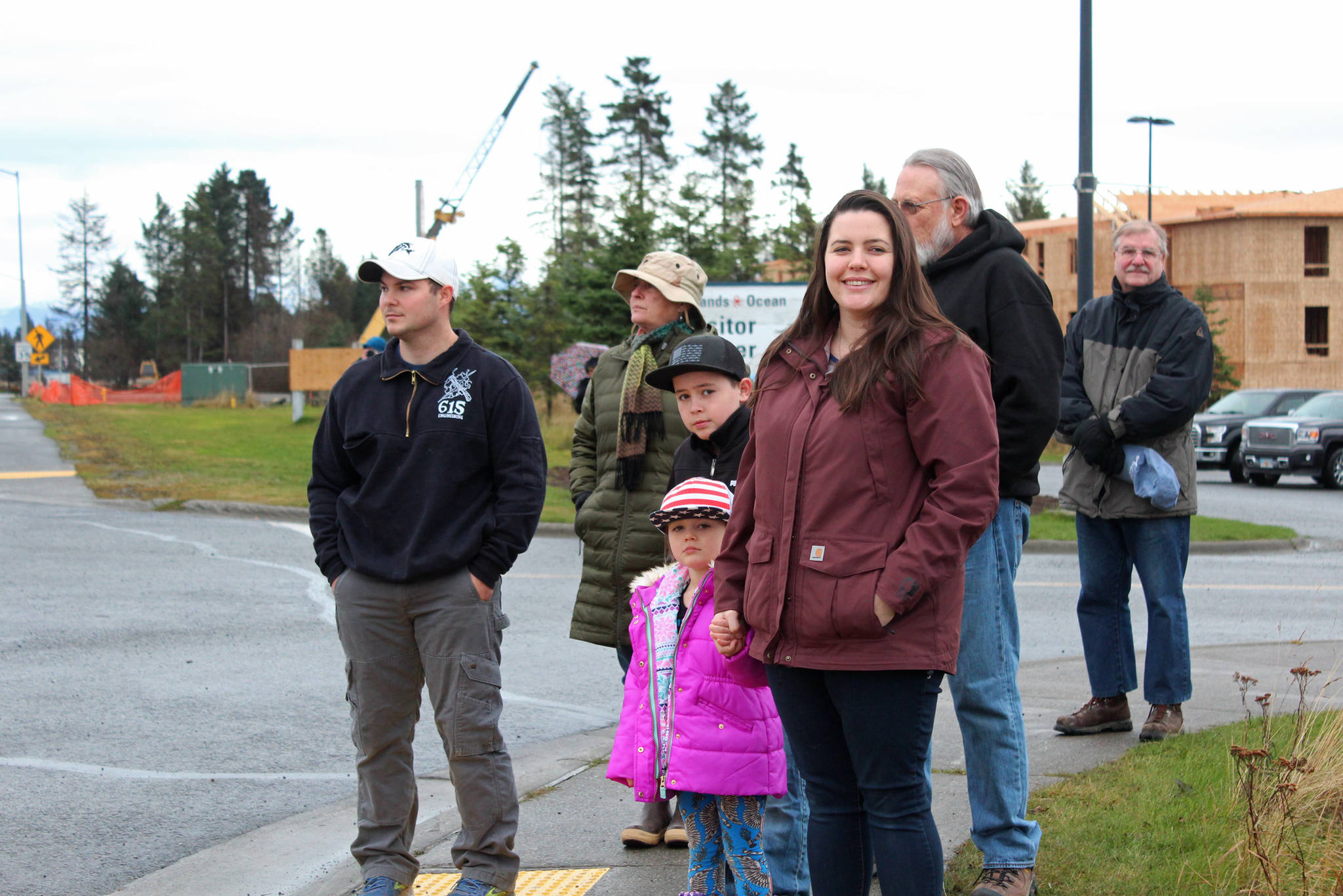 Onlookers welcome a parade of veterans to the Alaska Islands and Oceans Center for a ceremony after the parade held Sunday, Nov. 11, 2018 in Homer, Alaska. (Photo by Megan Pacer/Homer News)