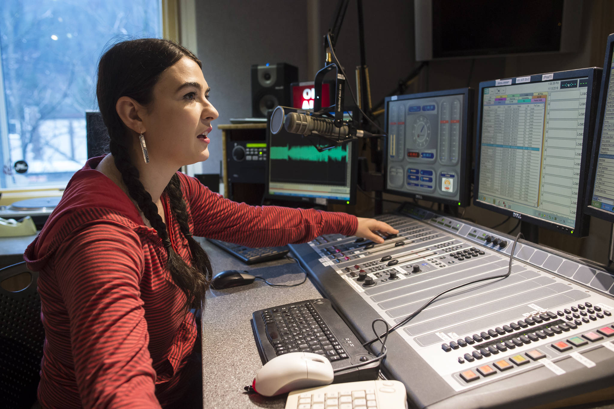 Annie Bartholomew, Program Director and host for KXLL-FM, has helped find five songs from Alaska artists in the first round of nominees intended to replace the state’s existing telephone hold music. (Michael Penn | Juneau Empire)