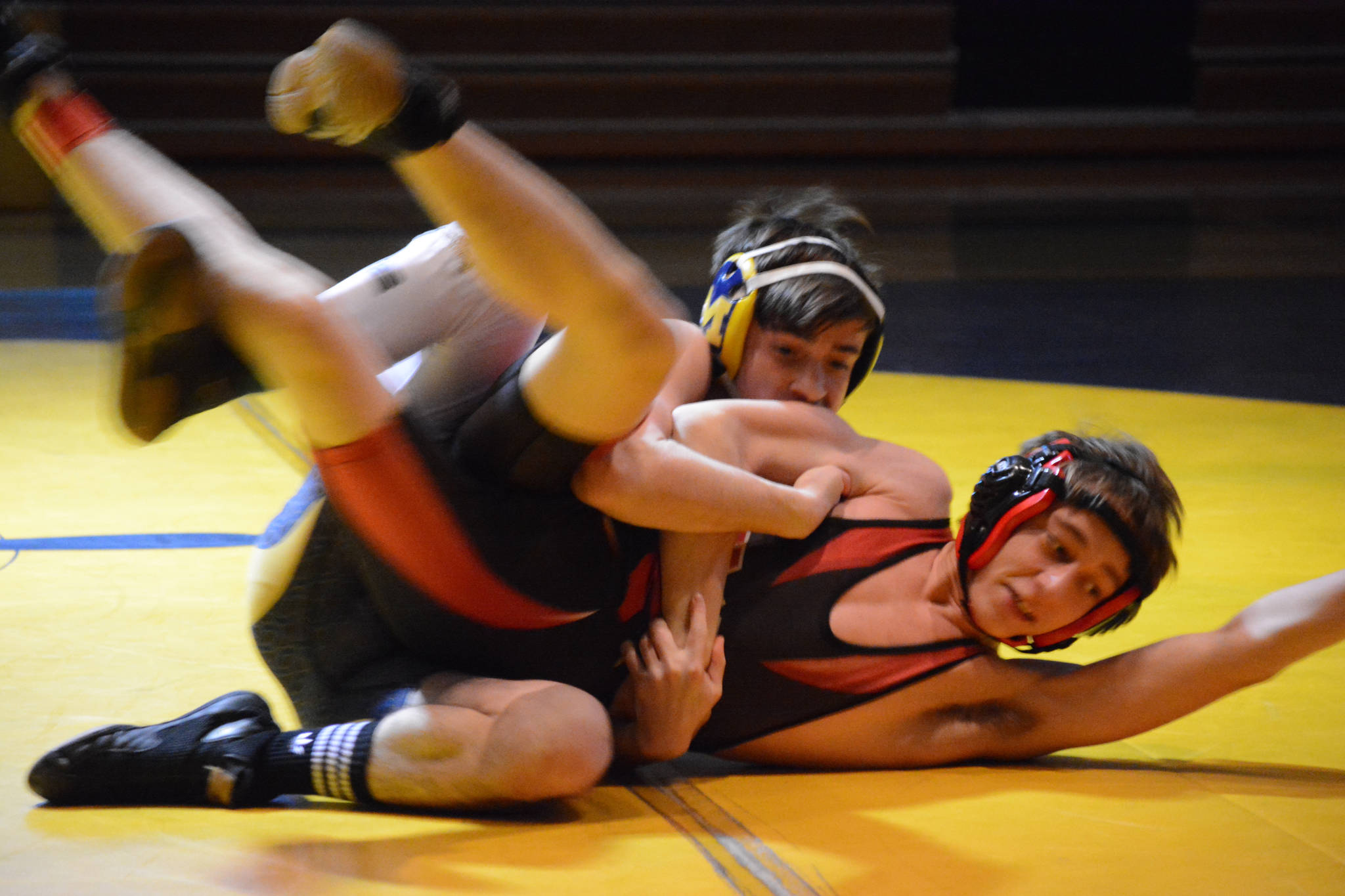 Homer High School Mariner Seth Inama, top, wrestles with Kenai High School Kardinal Daemon Duniphin, bottom, in a meet held Wednesday, Nov. 21, 2018, at the Homer High School Alice Witte Gym in Homer, Alaska. (Photo by Michael Armstrong/Homer News)