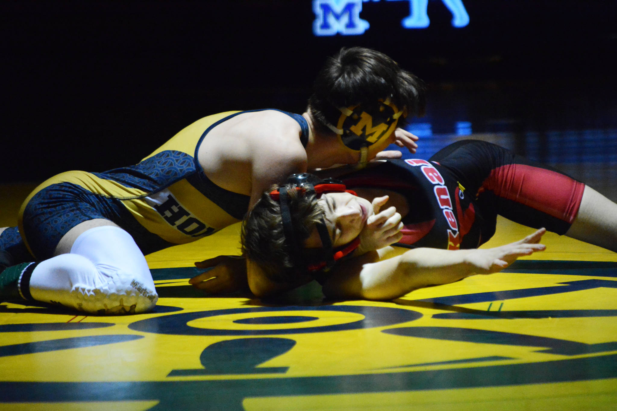 Homer High School Mariner Seth Inama, left, wrestles with Kenai High School Kardinal Daemon Duniphin, right, in a meet held Wednesday, Nov. 21, 2018, at the Homer High School Alice Witte Gym in Homer, Alaska. (Photo by Michael Armstrong/Homer News)