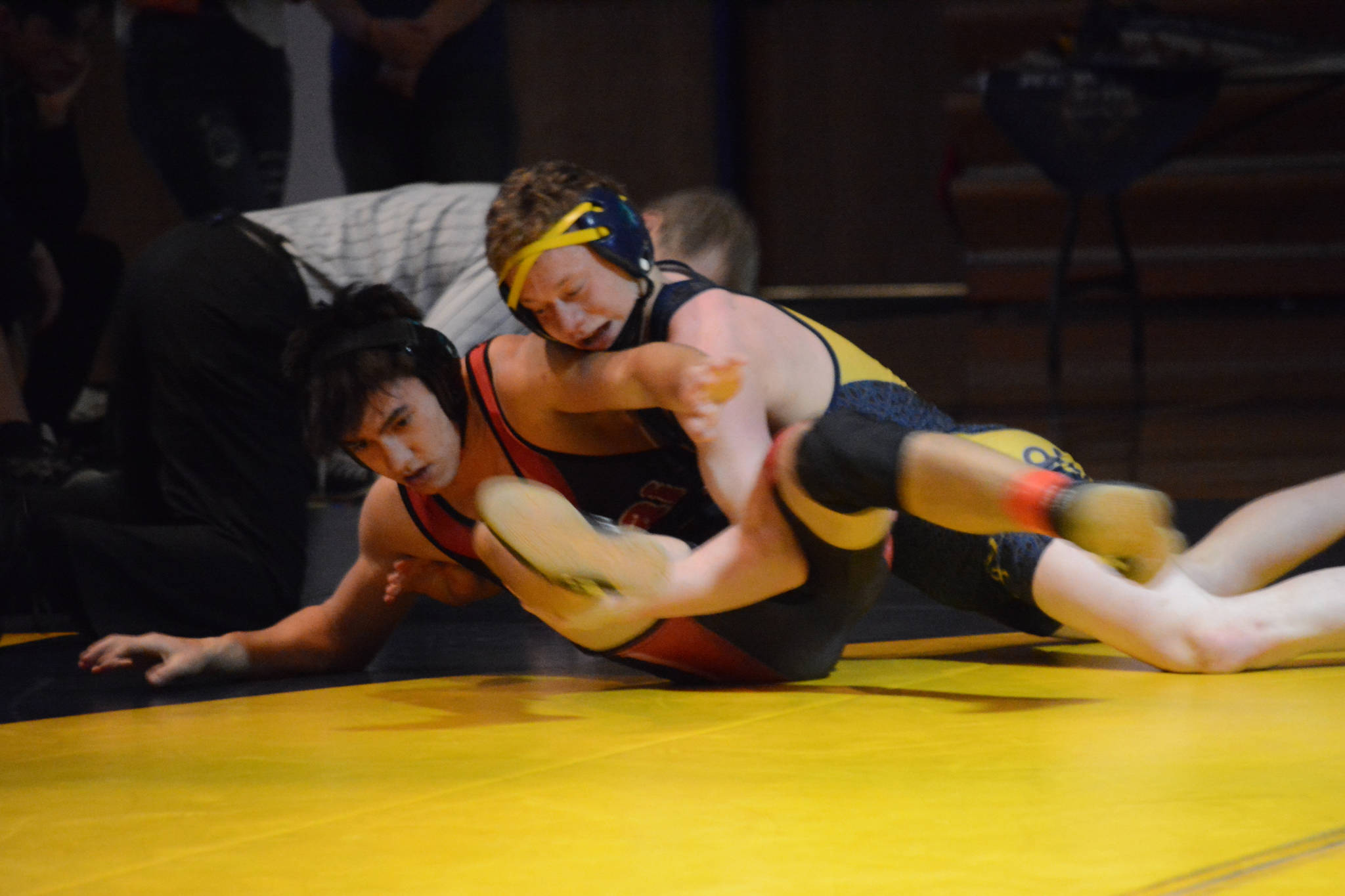Homer High School Mariner Mose Hayes, right, wrestles with Kenai High School Kardinal Brandon Koto, left, in a meet held Wednesday, Nov. 21, 2018, at the Homer High School Alice Witte Gym in Homer, Alaska. (Photo by Michael Armstrong/Homer News)