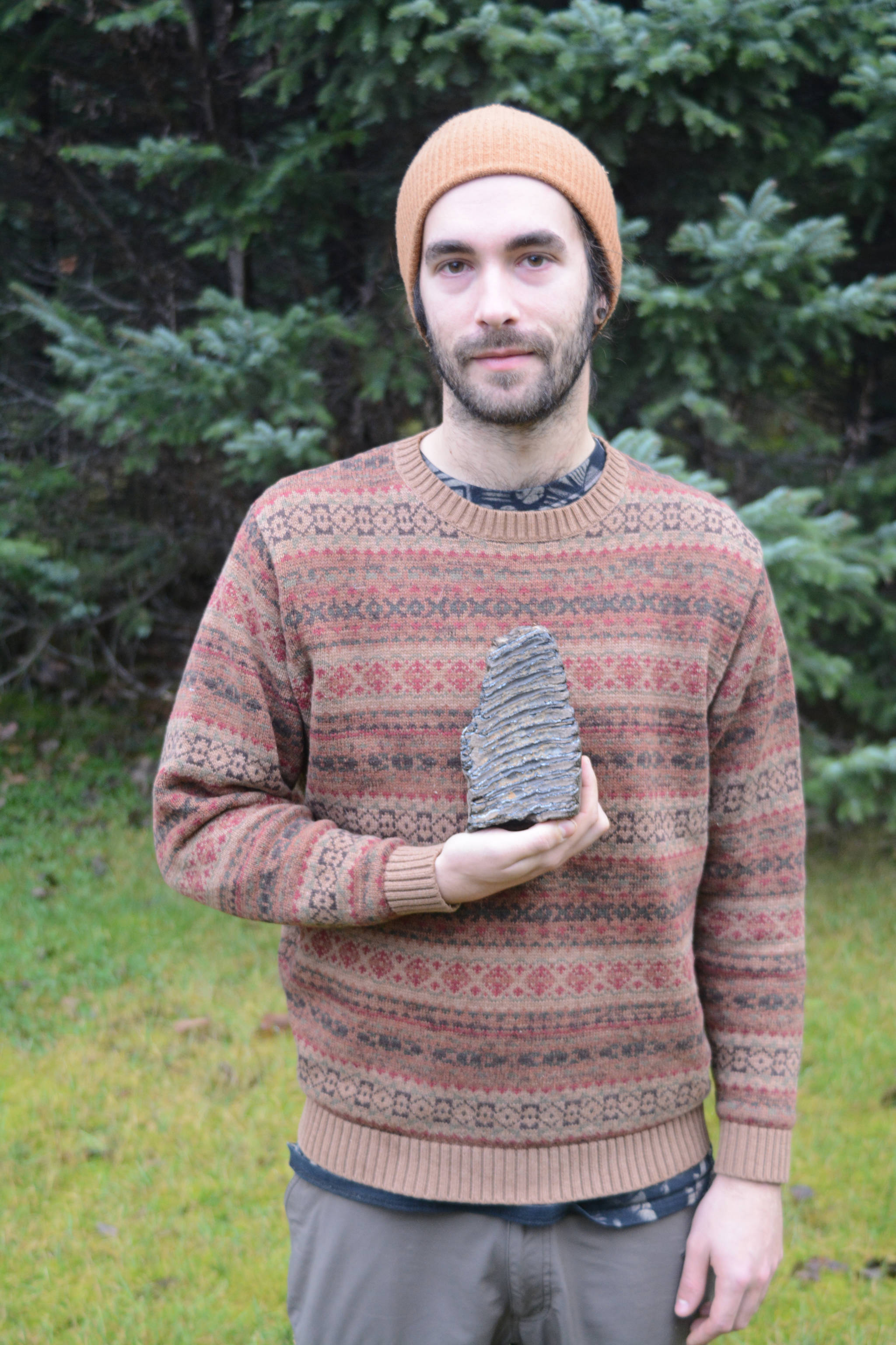 In a photo taken on Nov. 16, 2018, Aaron Carpenter holds a mammoth tooth he found on the beach north of Diamond Creek on Oct. 27, 2018, near Homer, Alaska. (Photo by Michael Armstrong/Homer News)