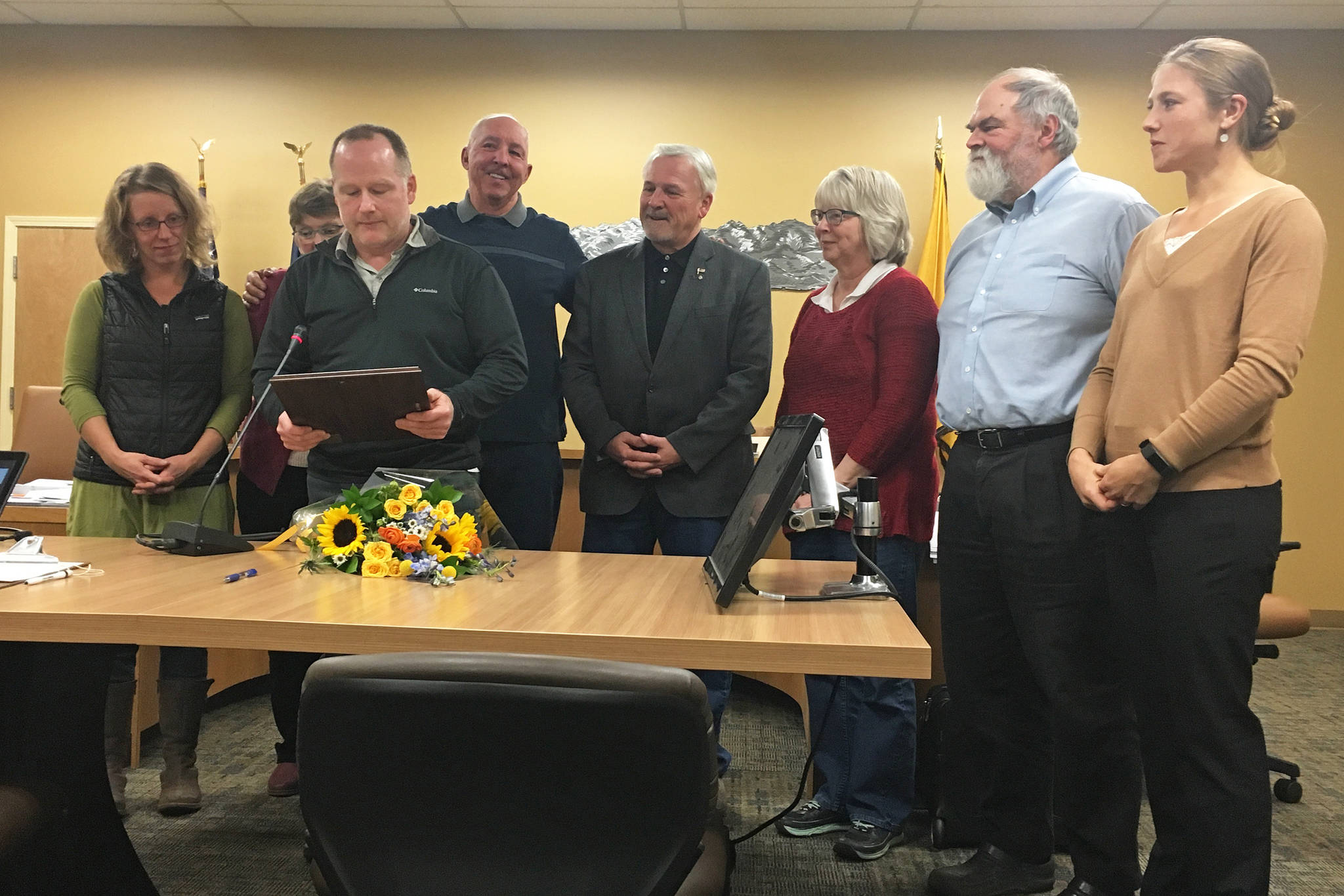 From left to right: Homer City Council members Rachel Lord, Caroline Venuti, Heath Smith, former Mayor Bryan Zak, council members Tom Stroozas and Shelly Erickson, Homer Mayor Ken Castner and City Manager Katie Koester celebrate an official recognition of Zak and his time serving the city during the council’s Monday, Nov. 26, 2018 meeting at Homer City Hall in Homer, Alaska. (Photo by Megan Pacer/Homer News)