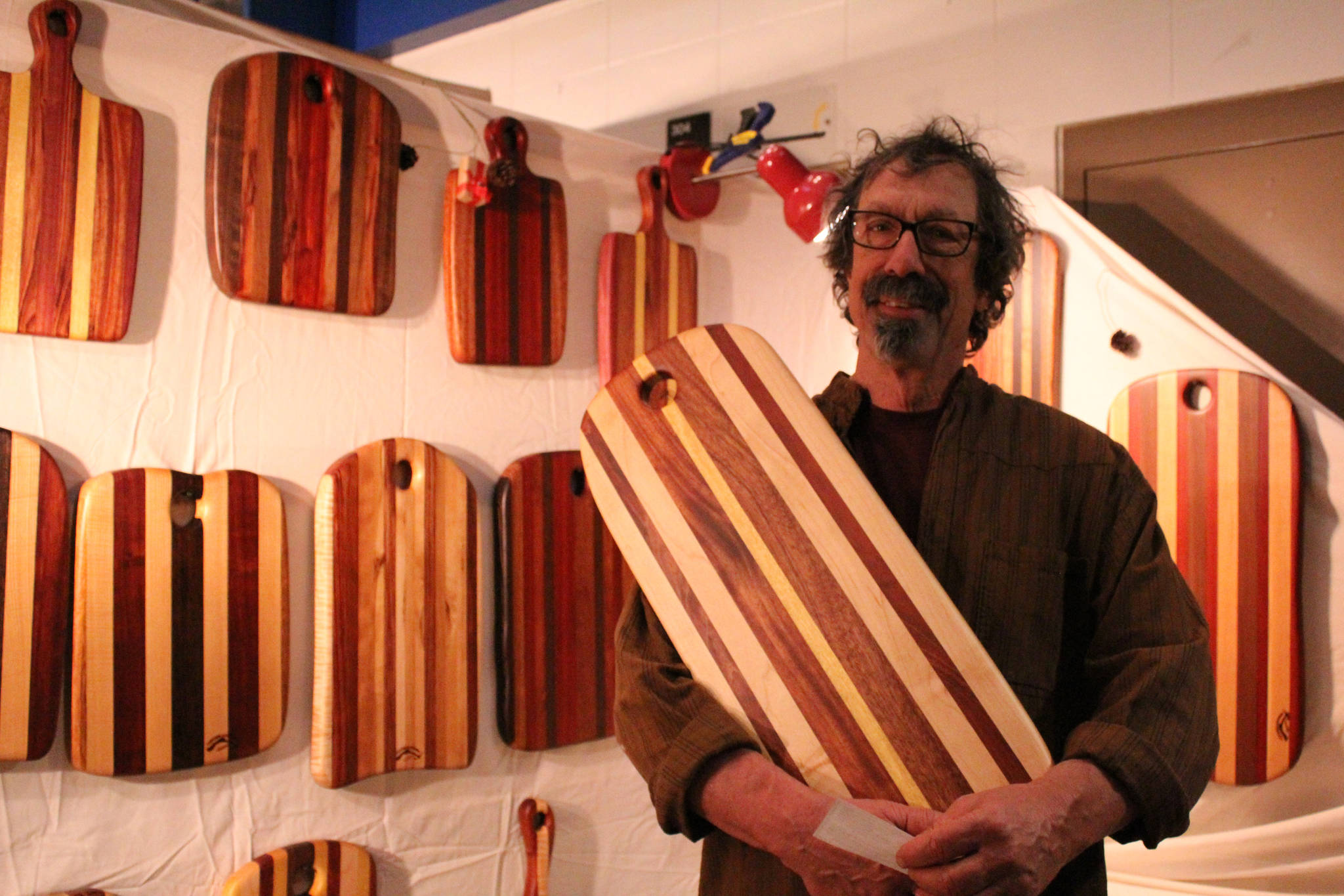Paul Pellegrini shows off one of his custom-made cutting boards at his Homer Woods booth at the Nutcracker Faire on Saturday, Dec. 3.