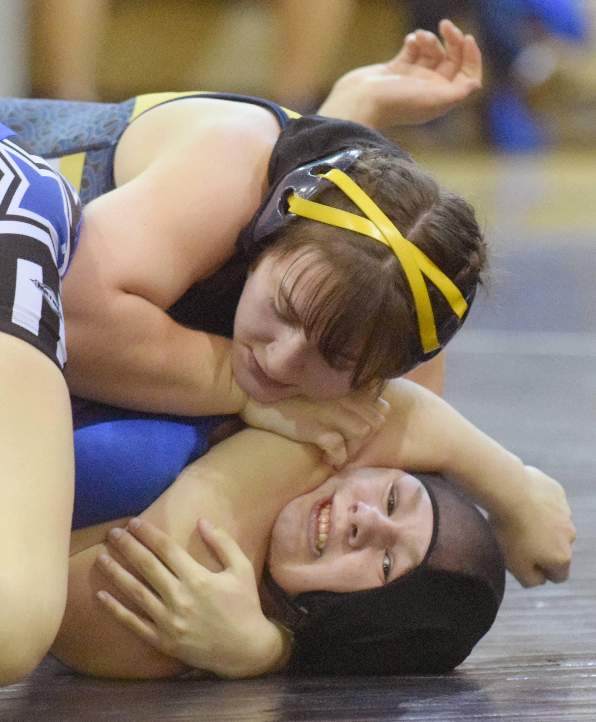 Homer’s McKenzie Cook controls Soldotna’s Amanda Wylie at 152 pounds Tuesday, Nov. 27, 2018, at Soldotna Prep in Soldotna, Alaska. Cook would pin Wylie. (Photo by Jeff Helminiak/Peninsula Clarion)