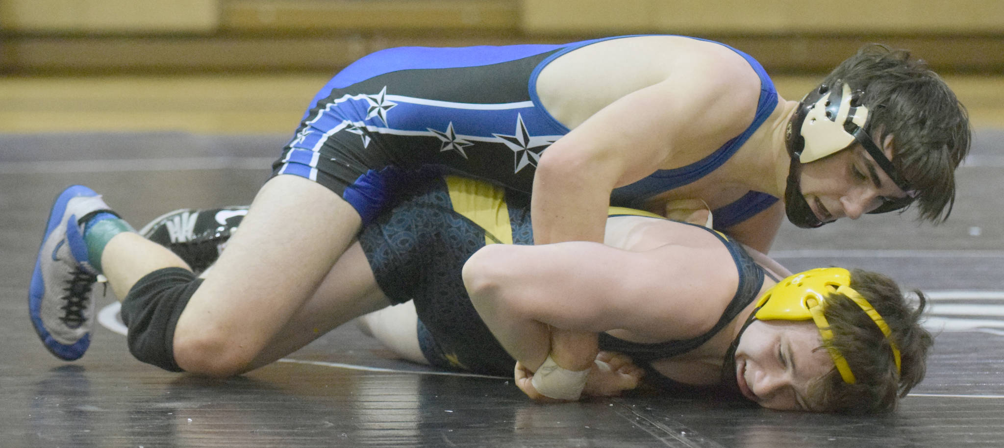 Soldotna’s Gideon Hutchison works his way to a pin of Homer’s Ian Stovall on Tuesday, Nov. 27, 2018, at Soldotna Prep in Soldotna, Alaska. (Photo by Jeff Helminiak/Peninsula Clarion)
