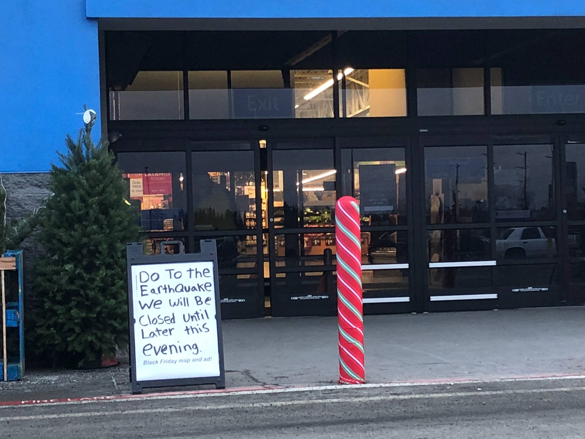 A sign stands outside the Walmart, in Kenai Alaska, on Friday, Nov. 30 informing customers that business is closed due to earthquake damage. (Photo by Victoria Petersen/Peninsula Clarion)