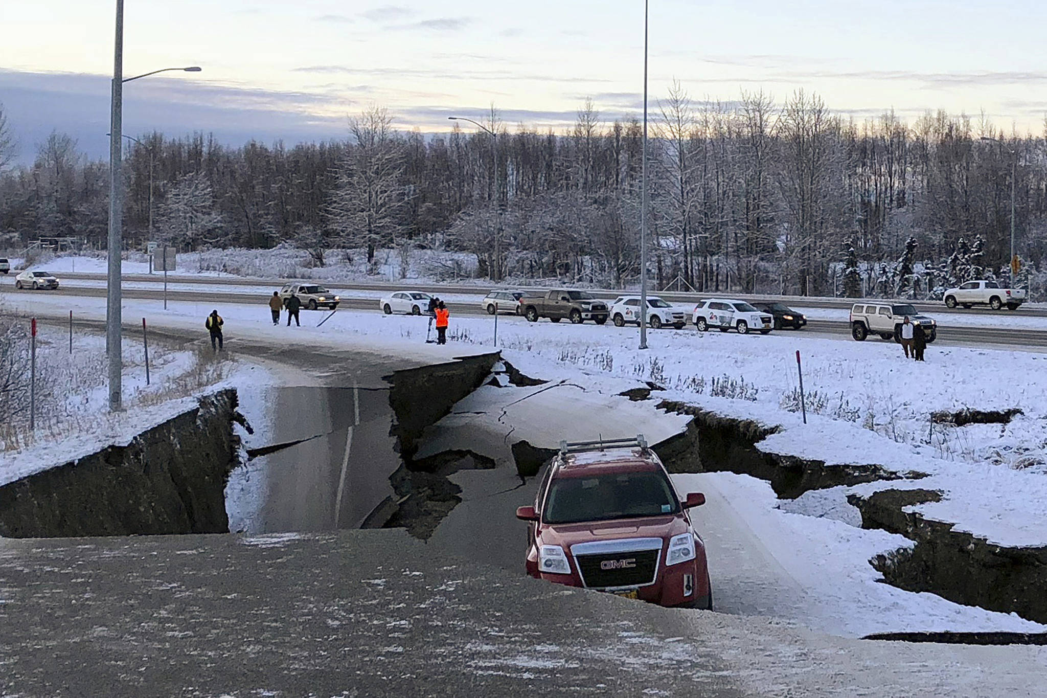 A car A car belonging to Homer resident Tom Sulczynski is trapped on a collapsed section of the offramp of Minnesota Drive in Anchorage, Friday, Nov. 30, 2018. Back-to-back earthquakes measuring 7.0 and 5.8 rocked buildings and buckled roads Friday morning in Anchorage, prompting people to run from their offices or seek shelter under office desks, while a tsunami warning had some seeking higher ground. (AP Photo/Dan Joling)