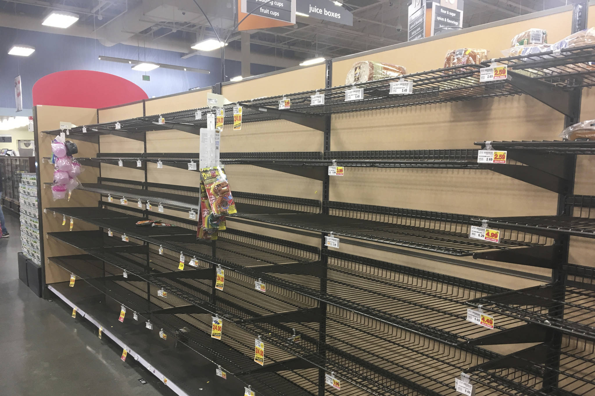 Empty shelves where bread is normally located are shown at a grocery store in Anchorage, Alaska, on Sunday, Dec. 2, 2018, two days after a magnitude 7.0 earthquake was centered about 7 miles north of the city. Anchorage officials urged residents not to stock up and hoard supplies because the supply chain of goods was not interrupted. (AP Photo/Mark Thiessen)