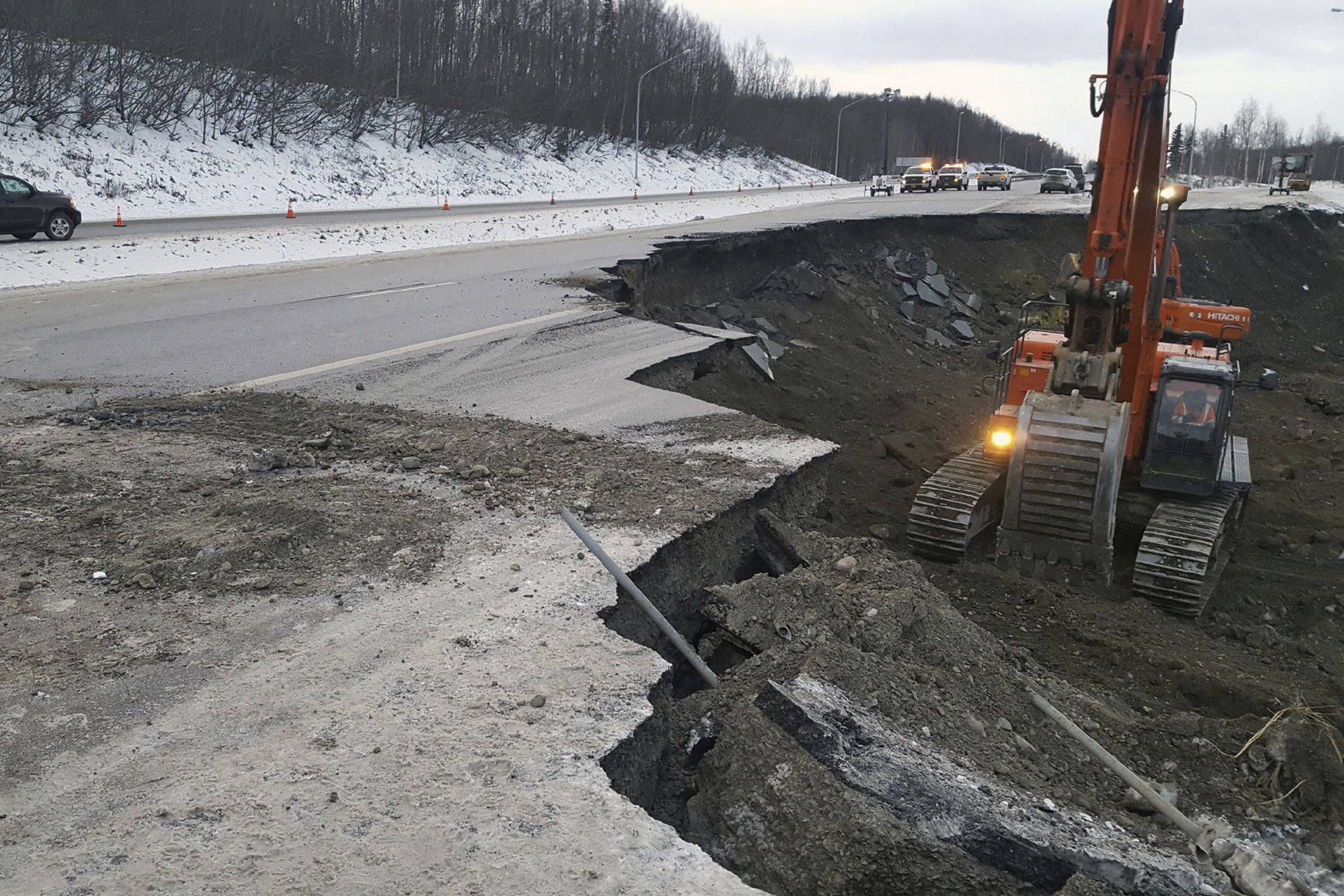 This photo provided by Chris Riekena shows excavation work being conducted Saturday, Dec. 1, 2018, near the Mirror Lake exit of the Glenn Highway near Eklutna, Alaska, to make the highway ready for repaving. The highway was heavily damaged in several spots following a magnitude 7.0 earthquake on Nov. 30, 2018. (Chris Riekena via AP)