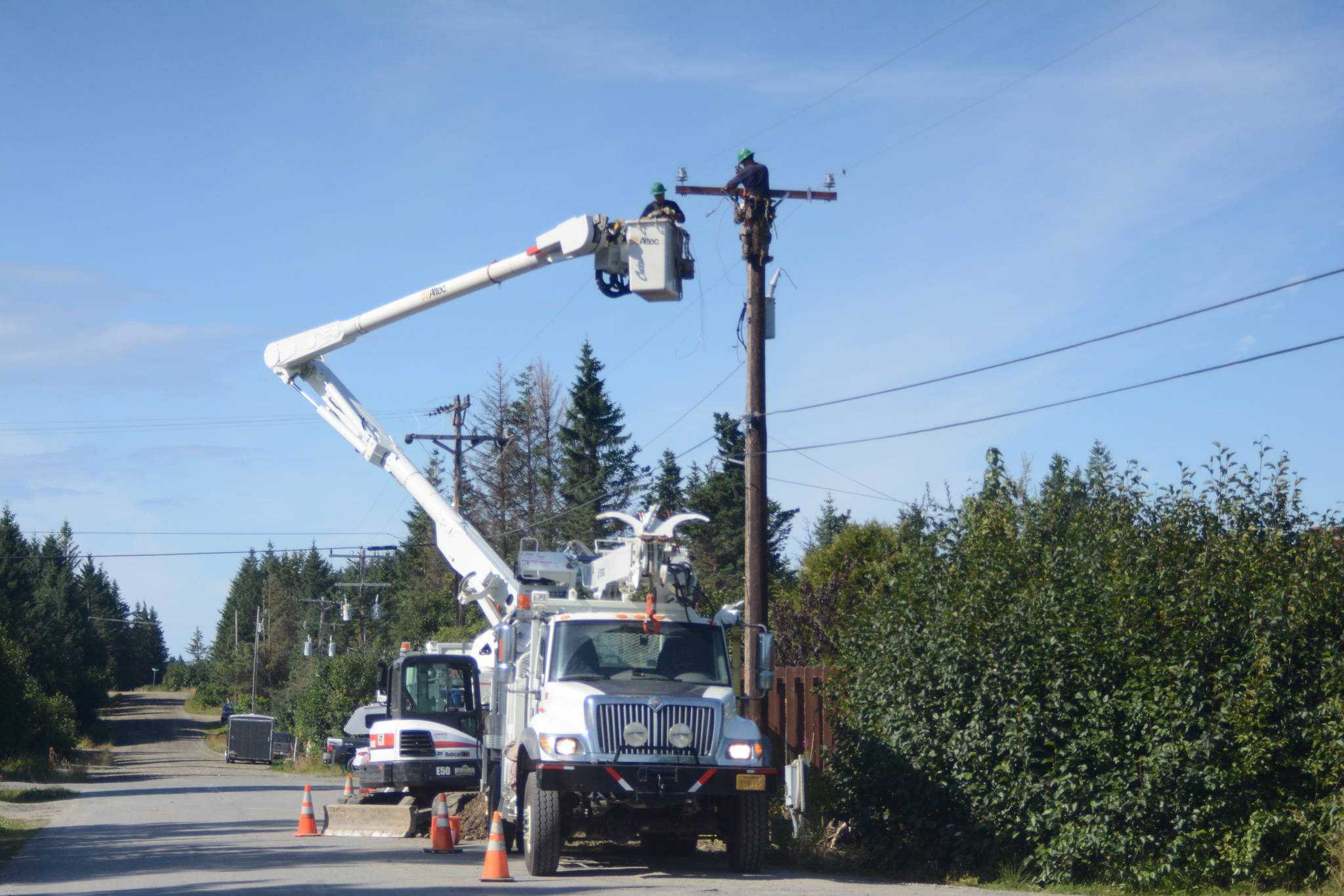 Homer Electric Association crews work on a powerline on Lake Street in Homer, Alaska, on Aug. 17, 2018. (Photo by Michael Armstrong/Homer News)