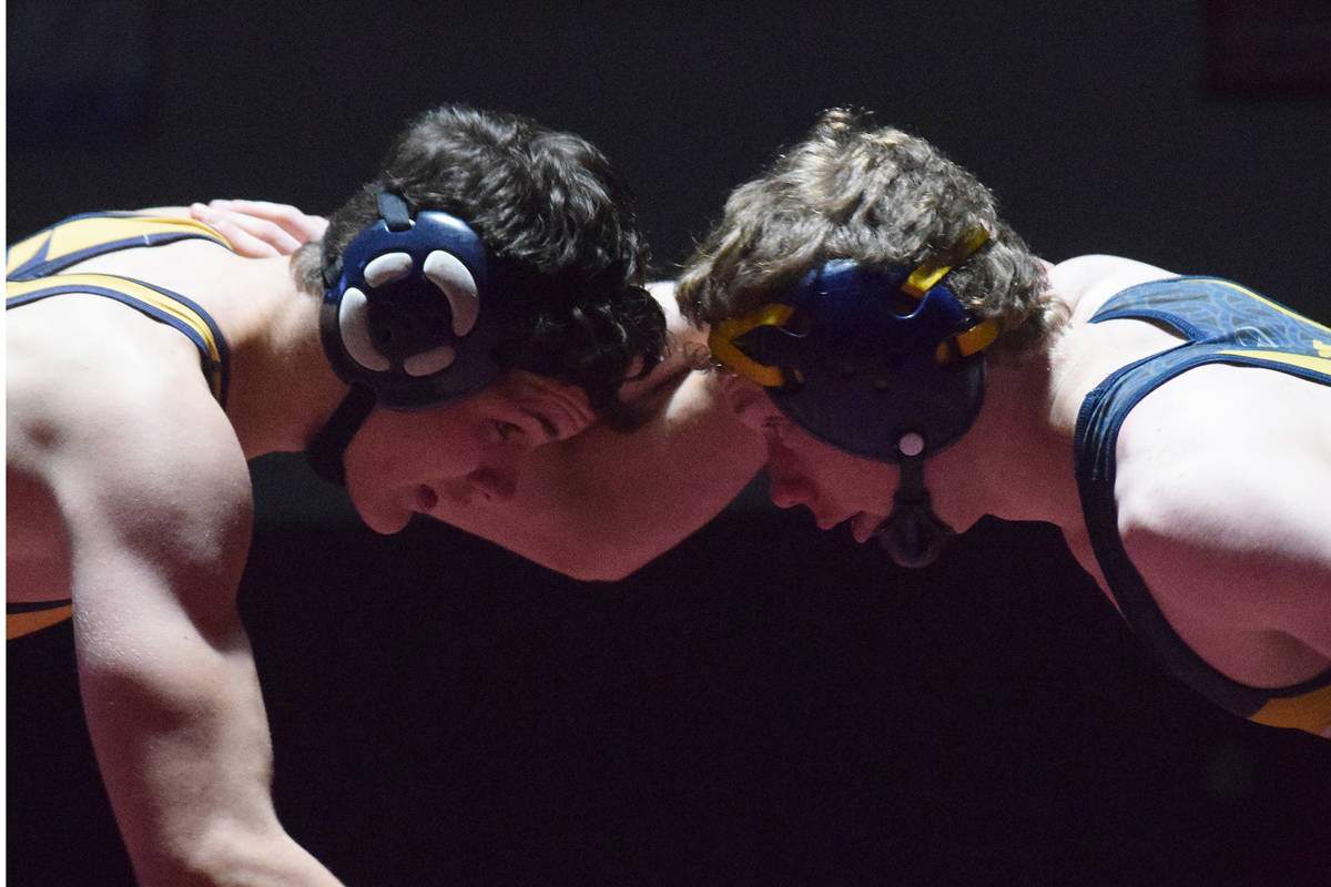 Homer teammates Josh Bradshaw (left) and Mose Hayes square off in the 152-pound championship Saturday, Dec. 8, 2018 at the Kachemak Conference wrestling tournament at Grace Christian High School in Anchorage, Alaska. (Photo by Joey Klecka/Peninsula Clarion)