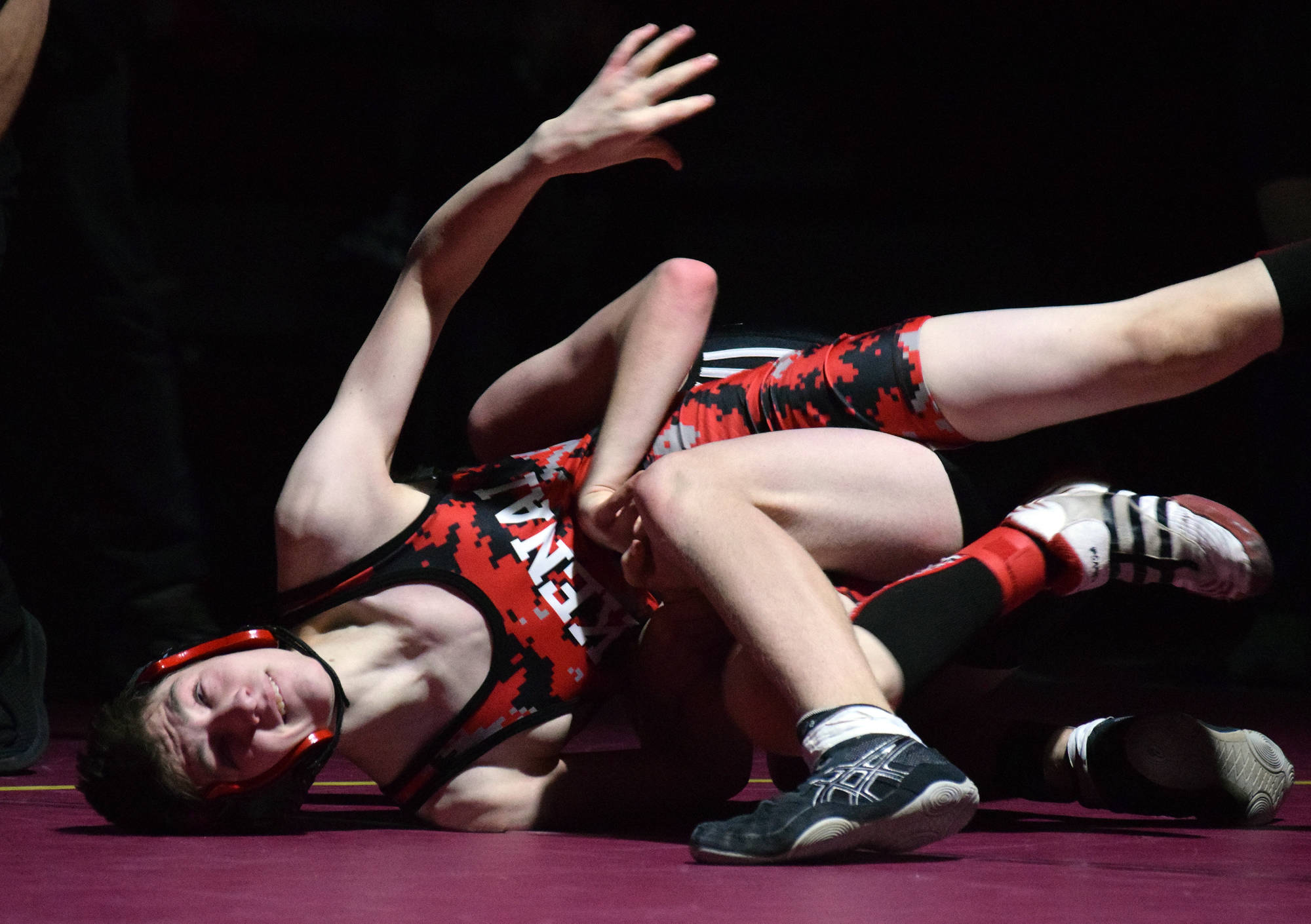 Kenai Central wrestler Talon Whicker fights against Nikiski’s Griffin Gray on Saturday, Dec. 8, 2018 at the Kachemak Conference wrestling tournament at Grace Christian High School in Anchorage, Alaska. (Photo by Joey Klecka/Peninsula Clarion)