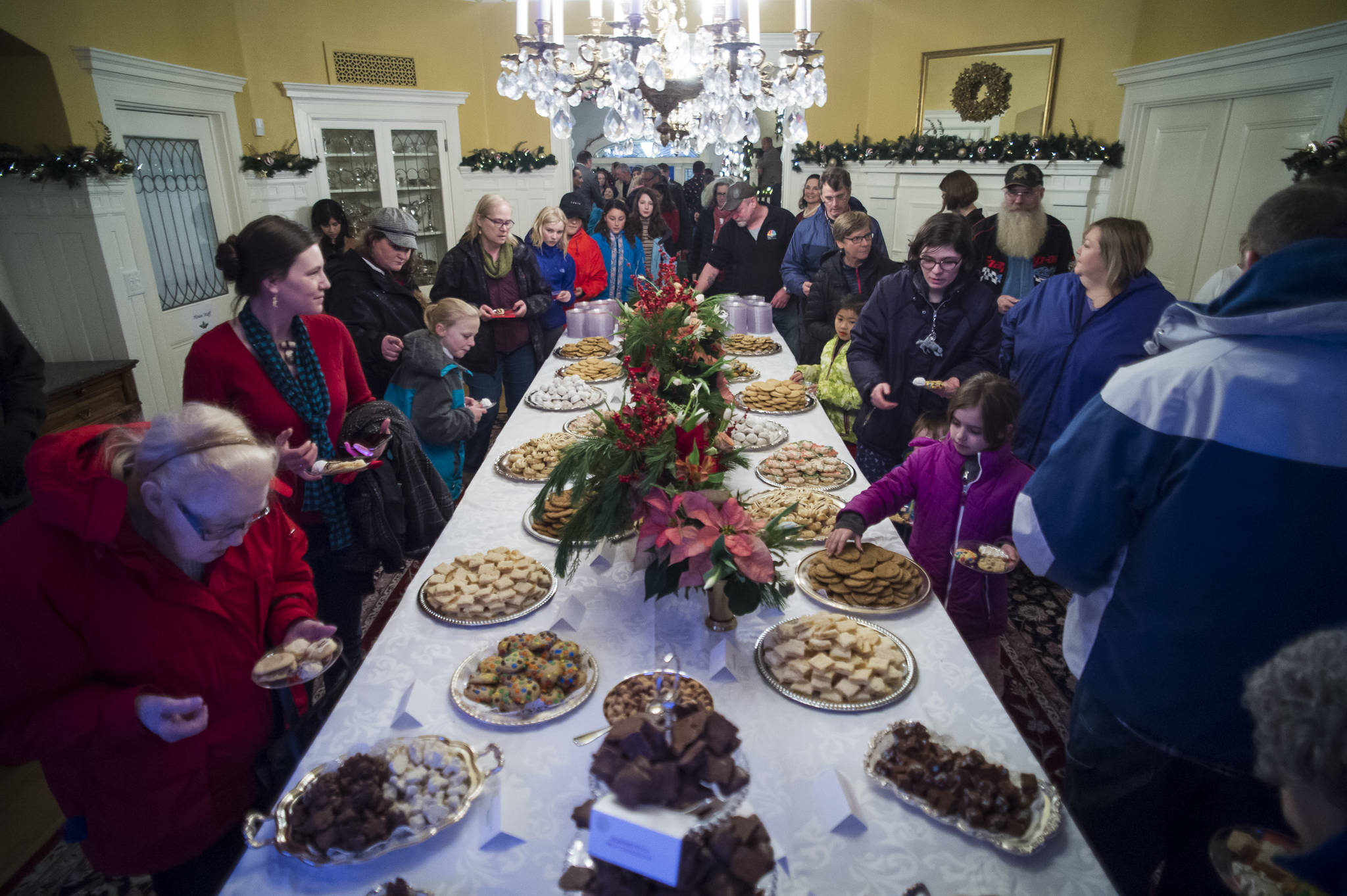 Juneau residents file through the dining room for cookies at the Governor’s Open House on Tuesday, Dec. 11, 2018. (Michael Penn | Juneau Empire)