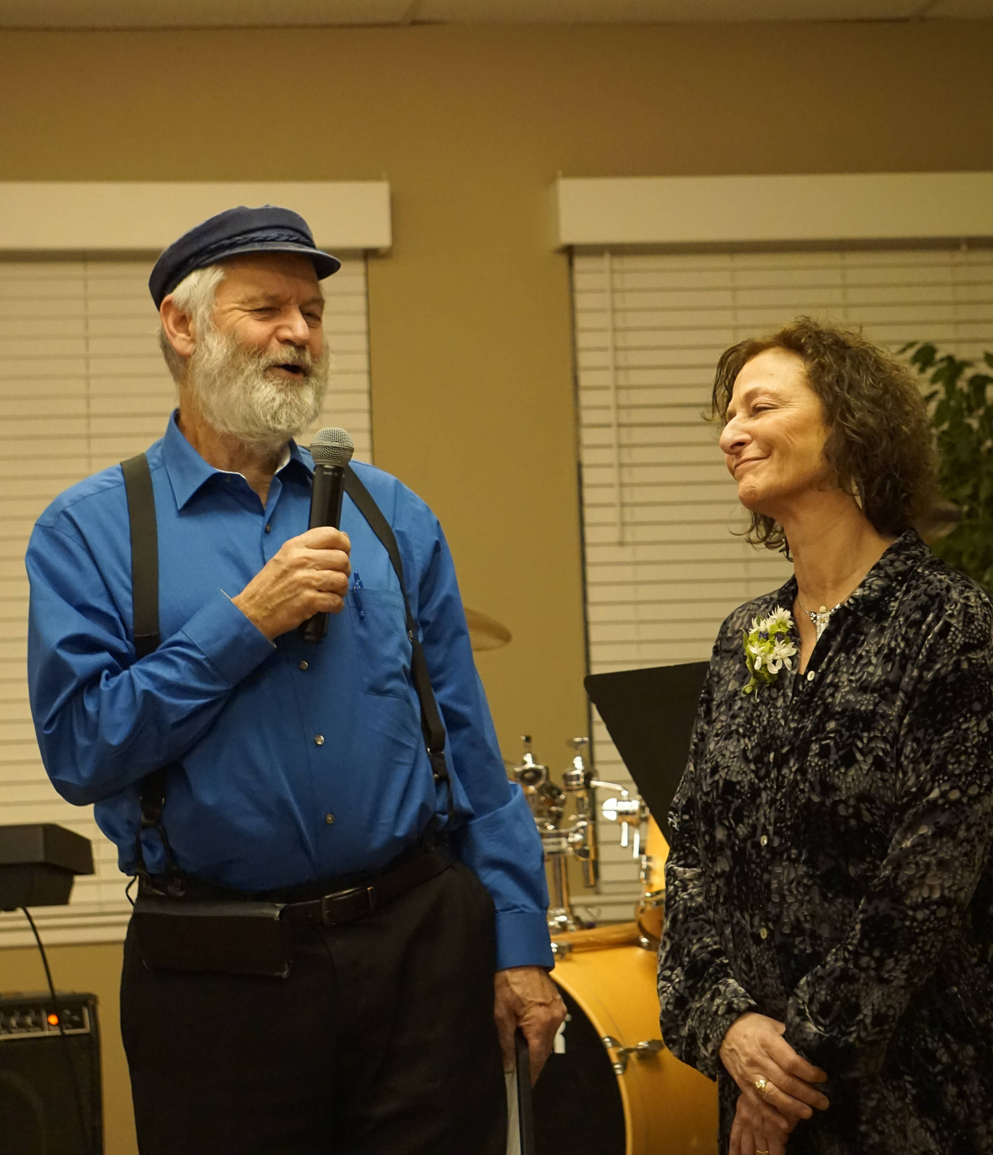 Kachemak Bay Campus Director Carol Swartz, right, smiles as Rep. Paul Seaton, NP-Homer, left, presents her with a Legislative Proclamation at her retirement party Land’s End Resort on Friday, Dec. 14, 2018 in Homer, Alaska. Swartz ends her job as director at the end of the year. Friends joined her in celebrating her tenure as director of the local branch campus of Kenai Peninsula College, University of Alaska Anchorage. (Photo by Michael Armstrong/Homer News)