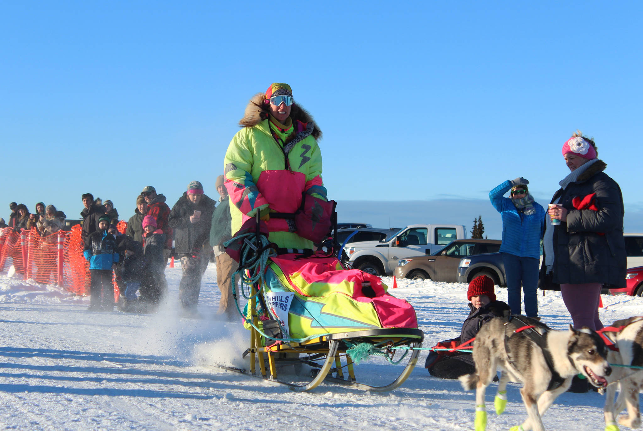 Monica Zappa, in her telltale neon garb, takes off with her team from the starting line of this year’s Tustumena 200 Sled Dog Race on Saturday, Jan. 27, 2018 at Freddie’s Roadhouse in Ninilchik, Alaska. (Homer News file photo)
