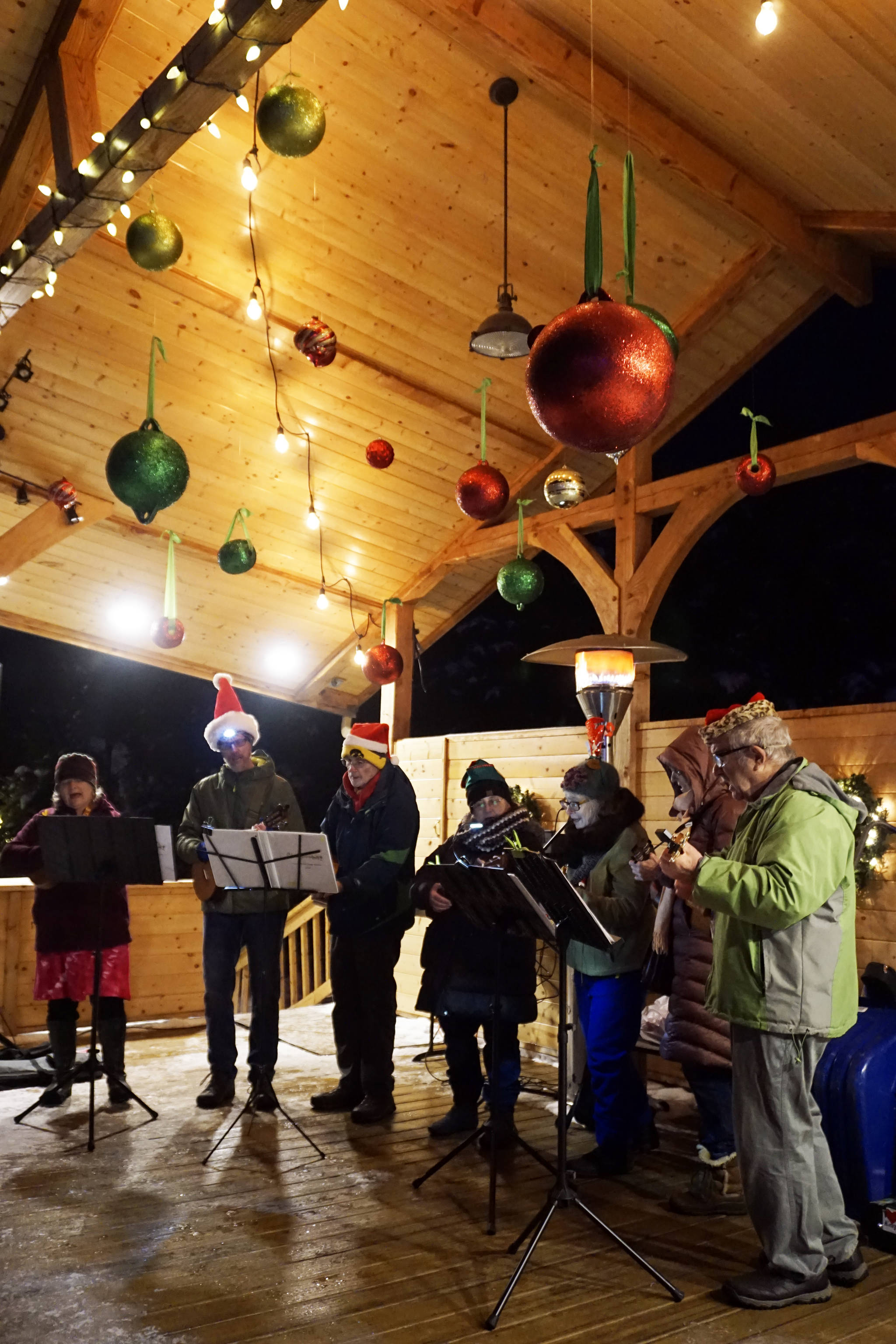 The Homer Ukulele Group performs at the Bear Creek Winery’s Garden Lights last Saturday, Dec. 22, 2018, in Kachemak City, Alaska. More than 500 people attended that night for an evening of music, colorful lights and hot beverages. (Photo by Michael Armstrong/Homer News)