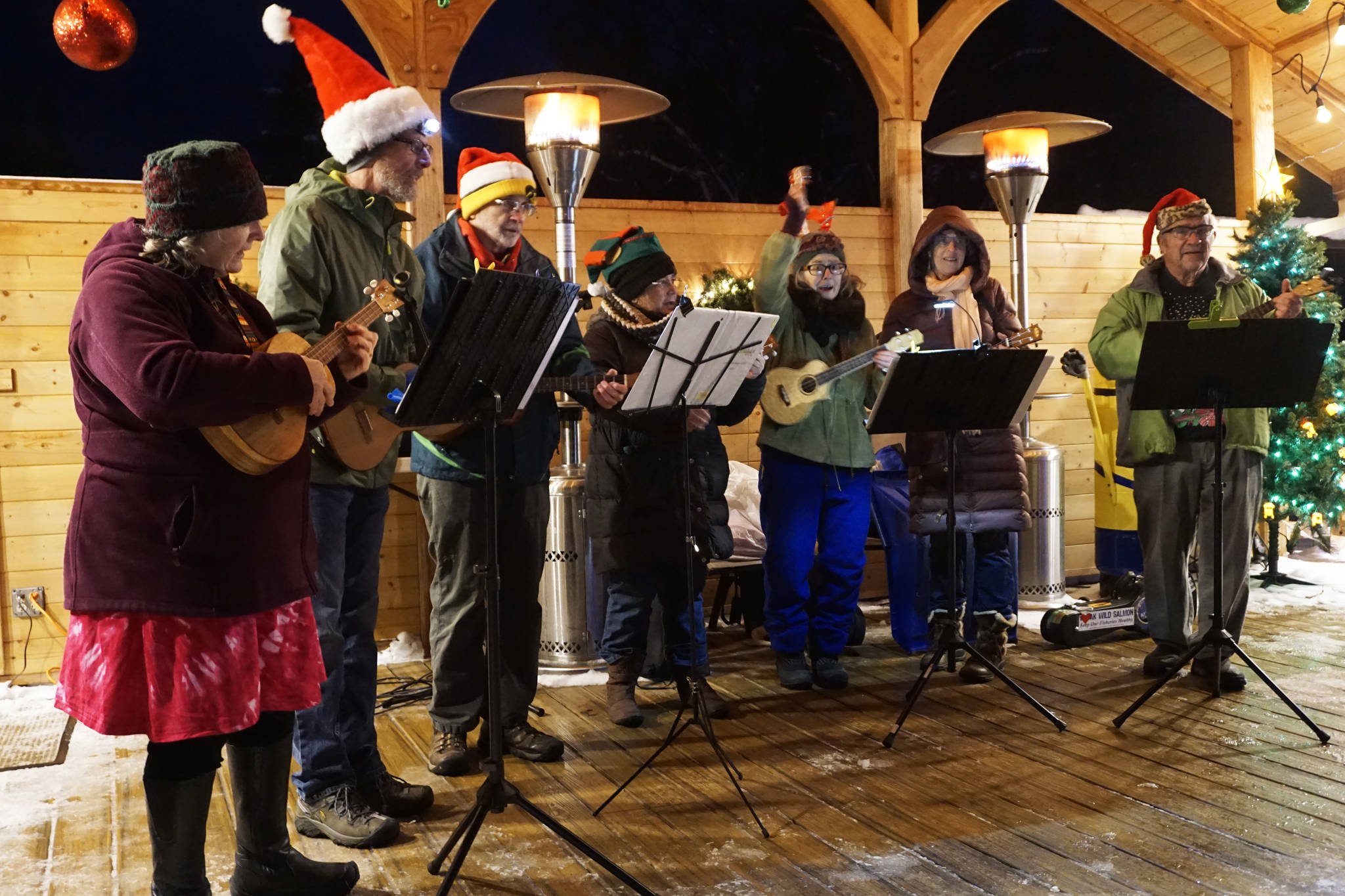 The Homer Ukulele Group performs at the Bear Creek Winery’s Garden Lights last Saturday, Dec. 22, 2018, in Kachemak City, Alaska. More than 500 people attended that night for an evening of music, colorful lights and hot beverages. (Photo by Michael Armstrong/Homer News)