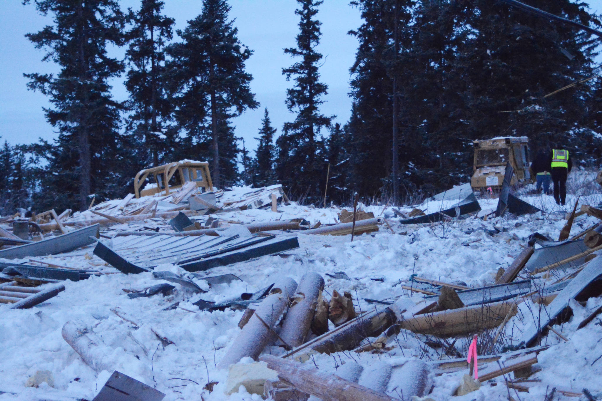 Kachemak Emergency Services Deputy Chief Joe Sallee inspects an exploded house near Mile 166 Sterling Highway on Friday, Dec. 28, 2018, near Homer, Alaska. The debris field from the explosion spread at least 200 feet in all directions. (Photo by Michael Armstrong/Homer News).
