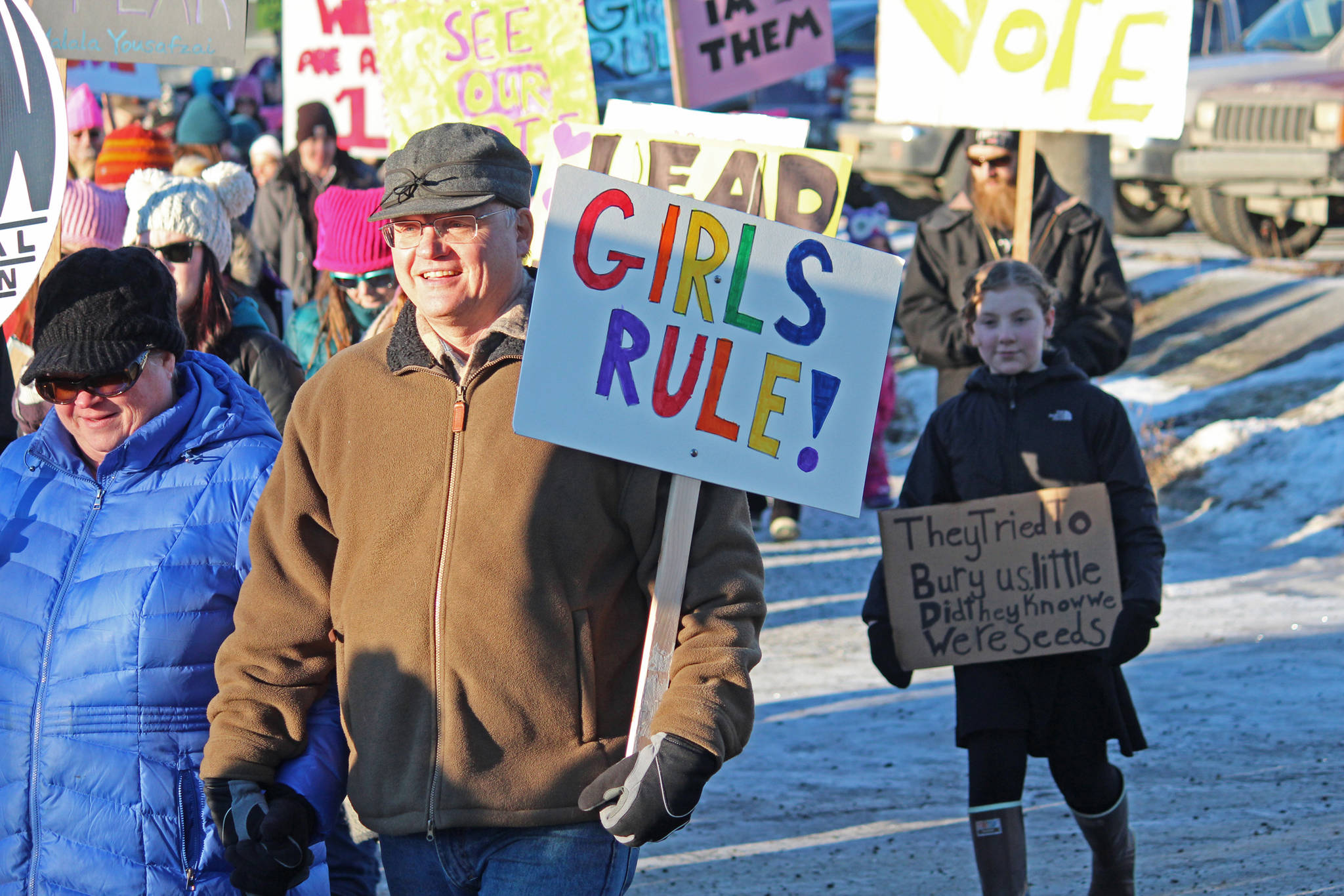 A man walks in the 2019 Women’s March on Homer while carrying a sign that reads “Girls Rule!” on Saturday, Jan. 19, 2019 in Homer, Alaska. (Photo by Megan Pacer/Homer News)
