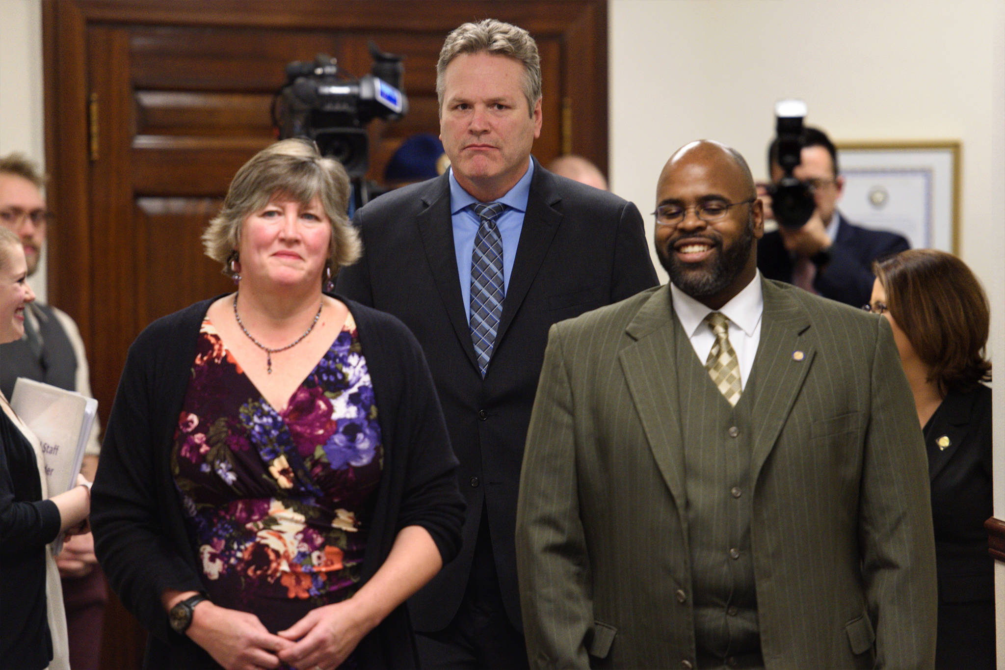 Gov. Mike Dunleavy walks into his State of the State speech in the House chamber at the Capitol in Juneau, Alaska, as Rep. Sara Hannan, D-Juneau, left, and Sen. David Wilson, R-Wasilla, walk into a Joint Session of the Alaska Legislature on Tuesday, Jan. 22, 2019. (Michael Penn | Juneau Empire)