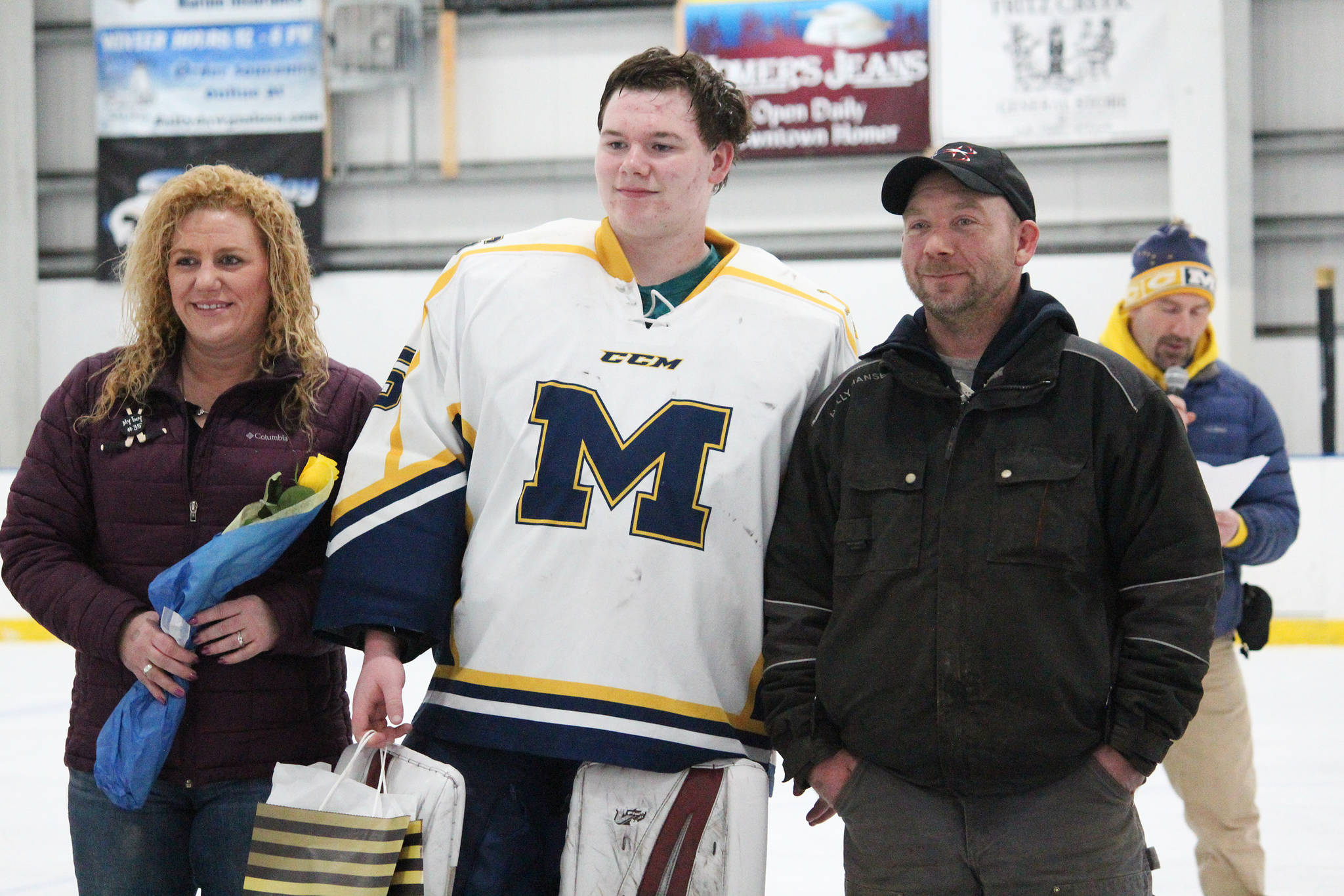 Homer senior Connor Roderick is honored with his parents on Senior Night for the Homer High School hockey team Thursday, Jan. 24, 2019 at Kevin Bell Ice Arena in Homer, Alaska. The Mariners defeated Houston High School 10-1. (Photo by Megan Pacer/Homer News)