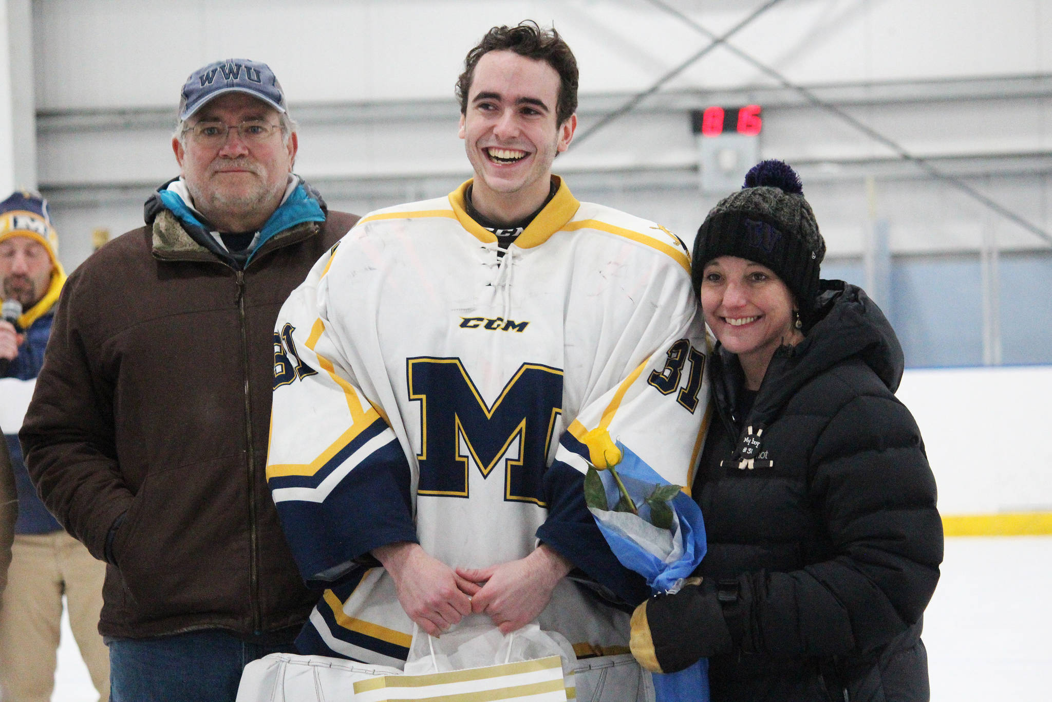 Homer senior Hunter Warren is honored with his parents on Senior Night for the Homer High School hockey team Thursday, Jan. 24, 2019 at Kevin Bell Ice Arena in Homer, Alaska. The Mariners defeated Houston High School 10-1. (Photo by Megan Pacer/Homer News)