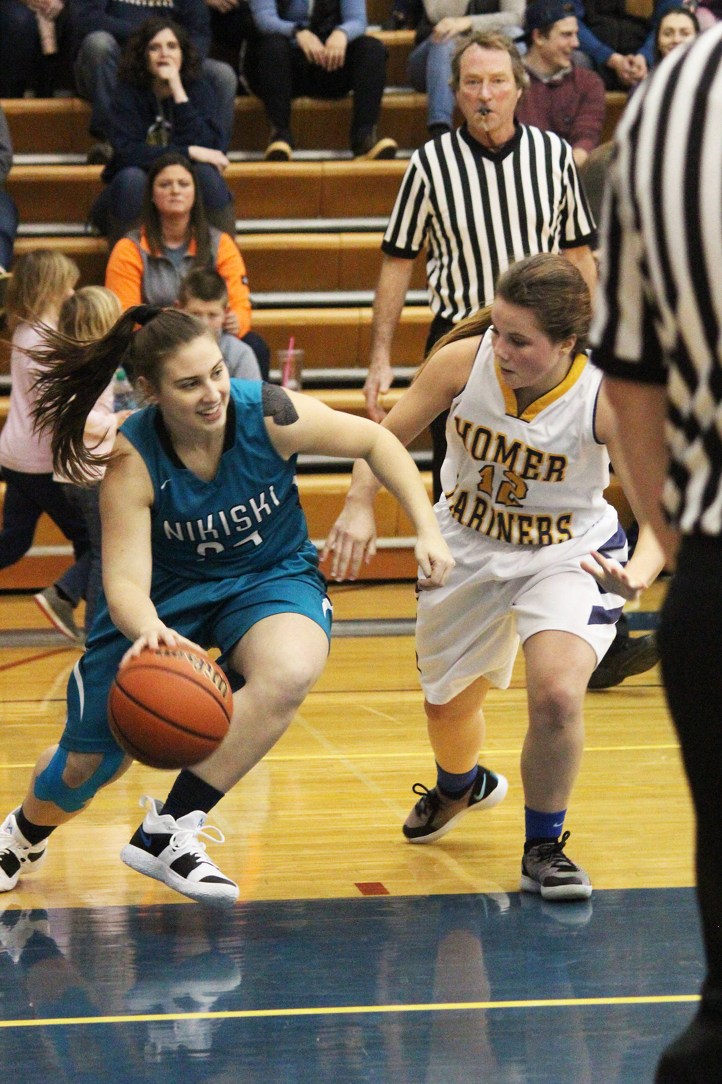 Nikiski’s Kelsey Clark looks for a way around Homer’s Rylee Doughty during a Friday, Jan. 25, 2019 matchup at the Alice Witte Gymnasium in Homer, Alaska. The Bulldogs rolled over the Lady Mariners 54-22. (Photo by Megan Pacer/Homer News)