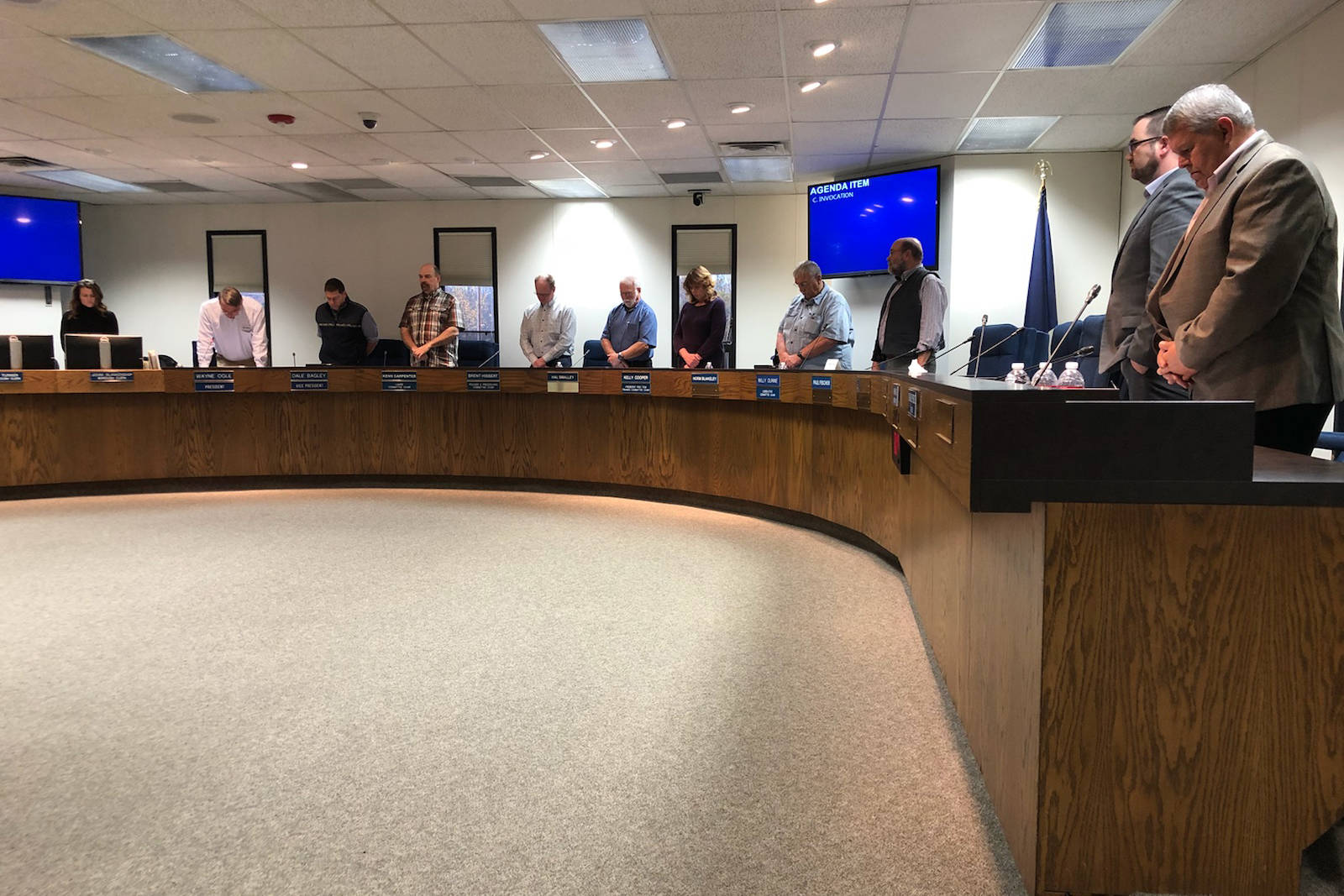 Members of the Kenai Peninsula Borough Assembly hold a religious invocation during the Tuesday, Oct. 9, 2018, assembly meeting in Soldotna, Alaska. The invocation was held only hours after the Alaska Superior Court ruled the ritual violated the Alaska Constitution. (Photo by Victoria Petersen/Peninsula Clarion)