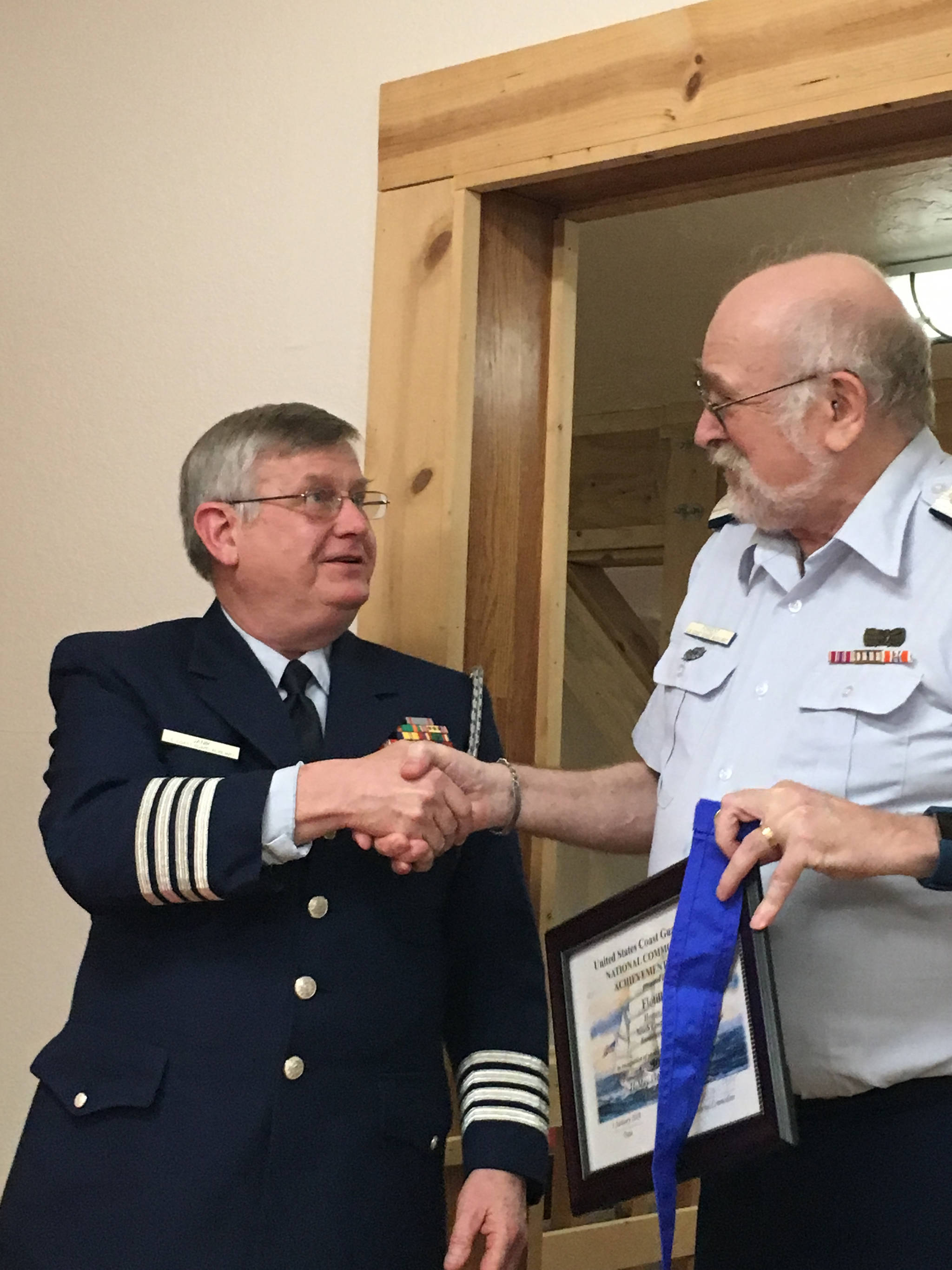 In this undated photo, District Chief of Staff Johnny Jannik presents Craig Forrest of Homer, a 40-year member of the United States Coast Guard Auxiliary Homer Flotilla, with the USCGA National Commodore’s Achievement Award marking the flotilla’s 50 years of service. (Photo courtesy of Craig Forrest )