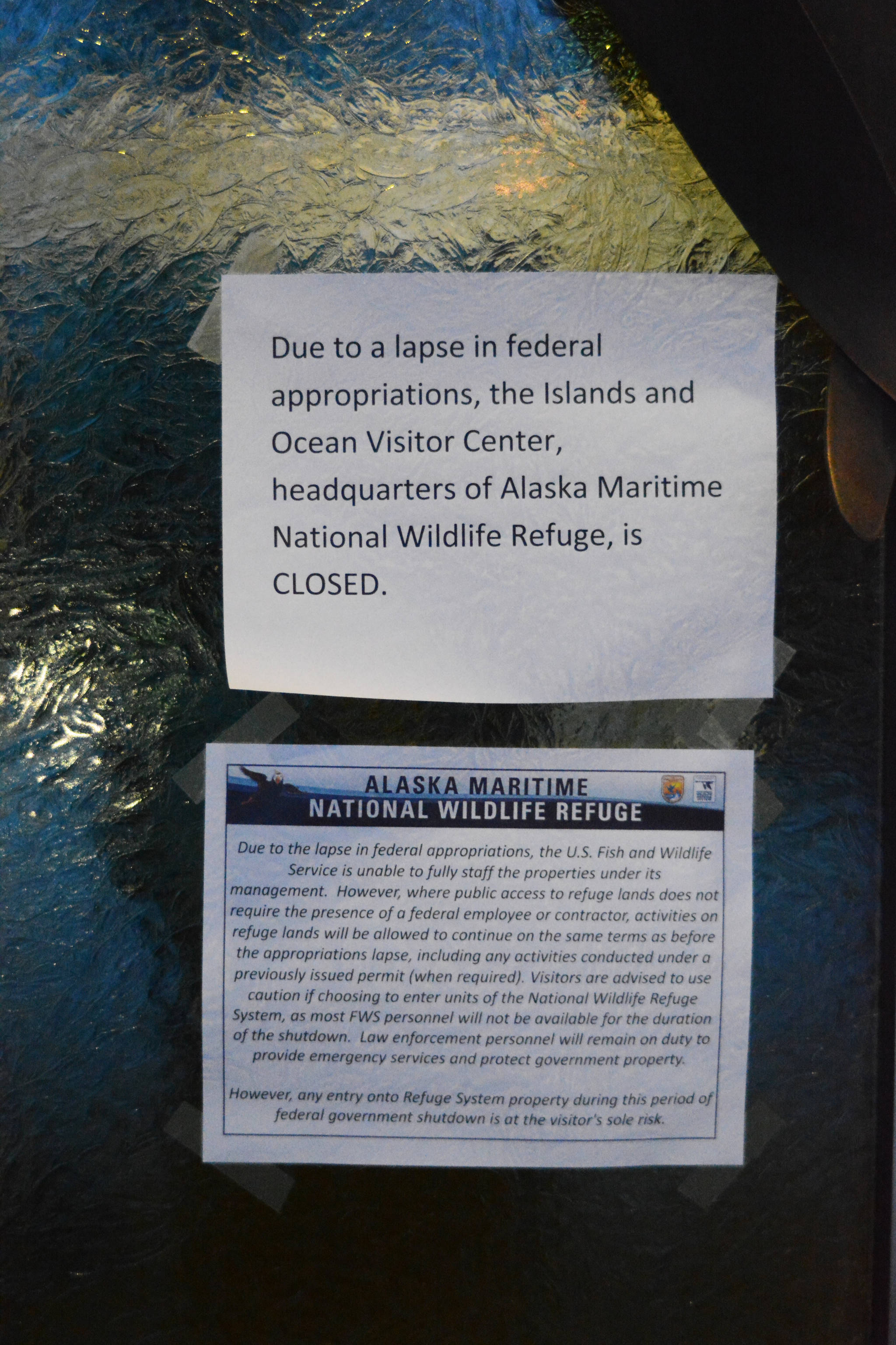 A sign on the door last Friday, Dec. 28, of the Alaska Islands and Ocean Visitor Center in Homer, Alaska, indicates that the headquarters of the Alaska Maritime National Wildlife Refuge is closed. Public access to refuge lands remains open, including a trail from the visitor center to Beluga Slough. (Photo by Michael Armstrong/Homer News)