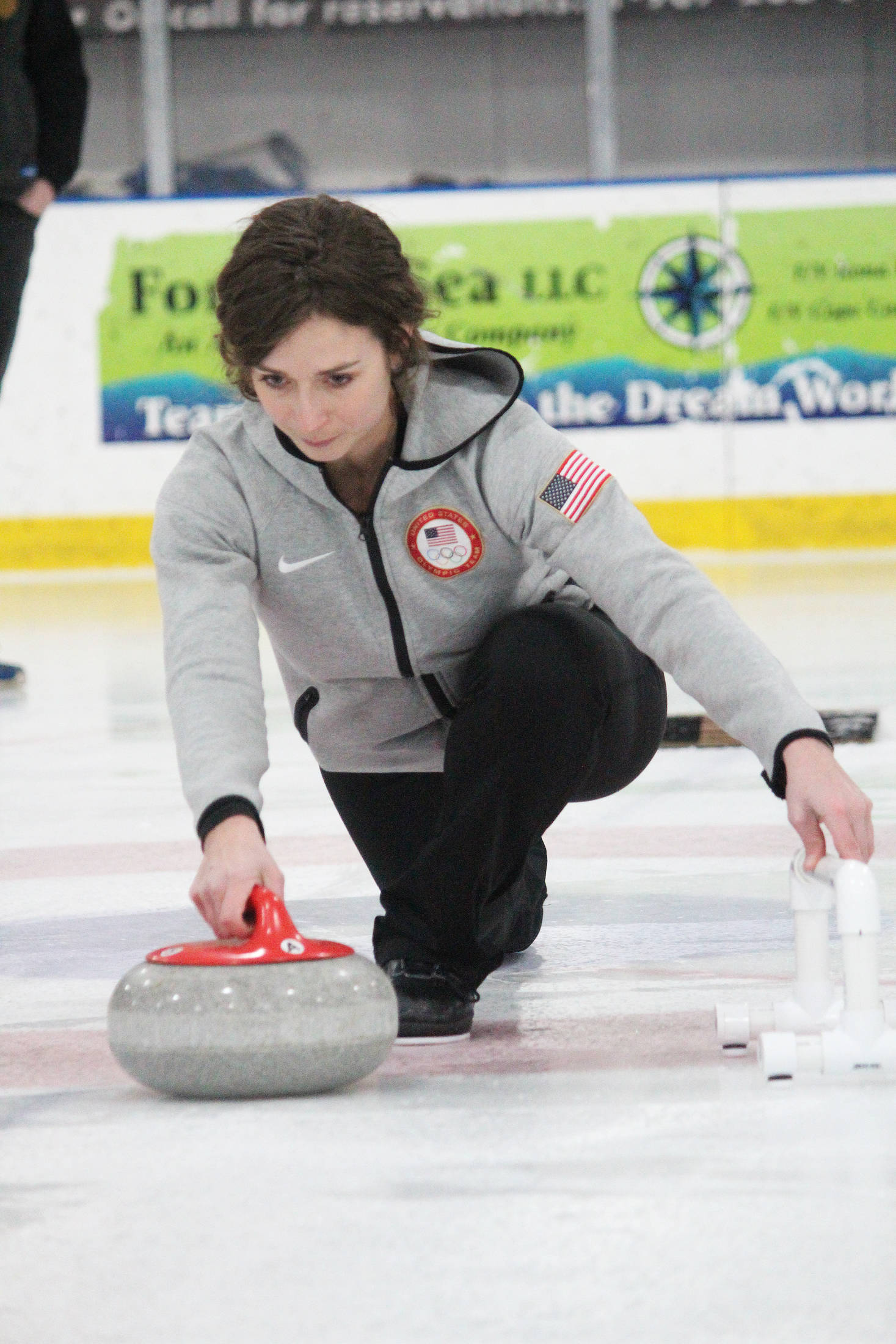 Former Olympic curler Jessica Schultz demonstrates the proper way to deliver a curling stone Saturday, Jan. 12, 2019 at the Kevin Bell Ice Arena in Homer, Alaska during a fundraiser event for the Homer Curling Club. (Photo by Megan Pacer/Homer News)