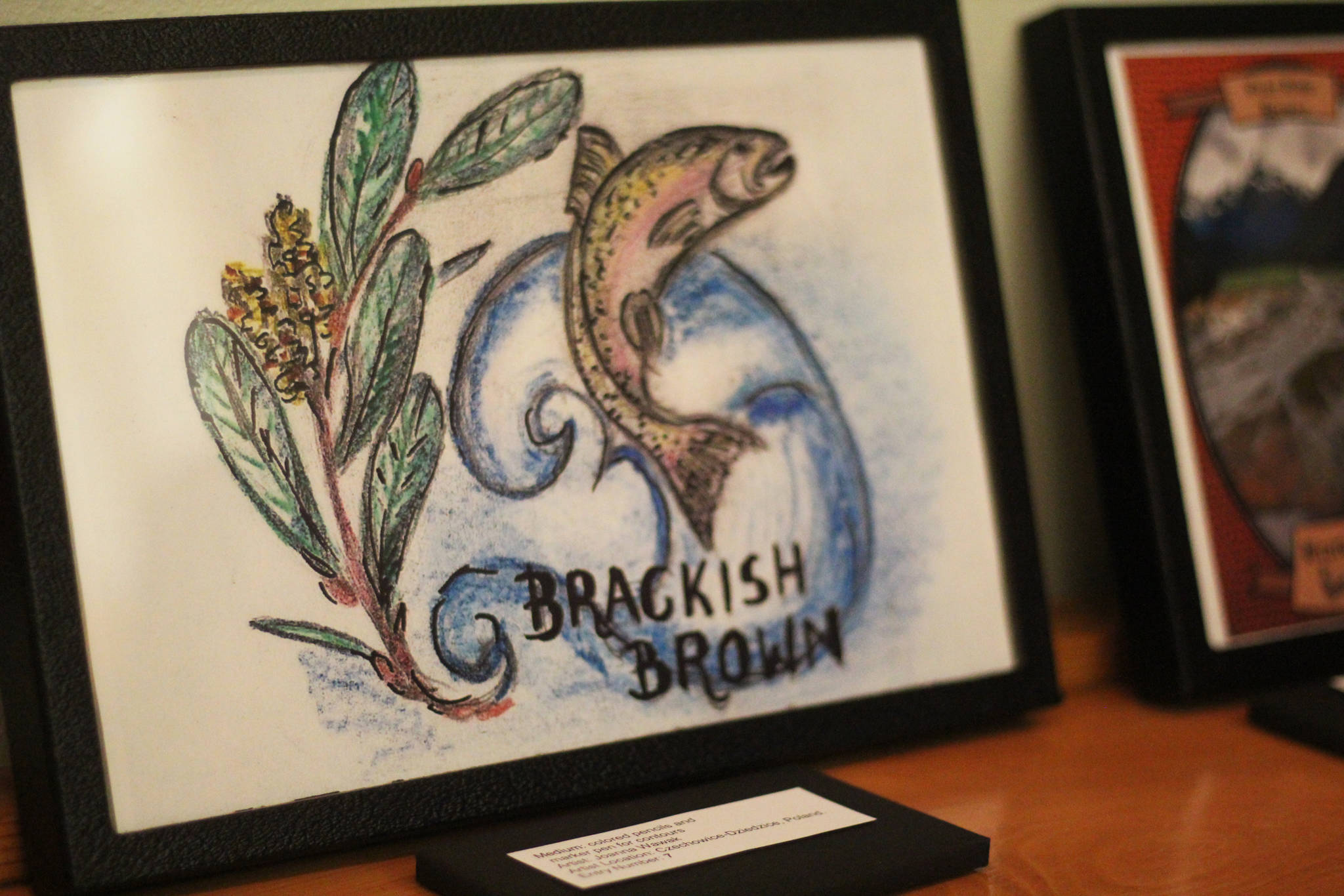 One of several beer label submissions sits on display Friday, Feb. 1, 2019 at a First Friday event at Grace Ridge Brewery in Homer, Alaska. The Brackish Brown ale, bottled with the winning label, was available at the event. (Photo by Megan Pacer/Homer News)