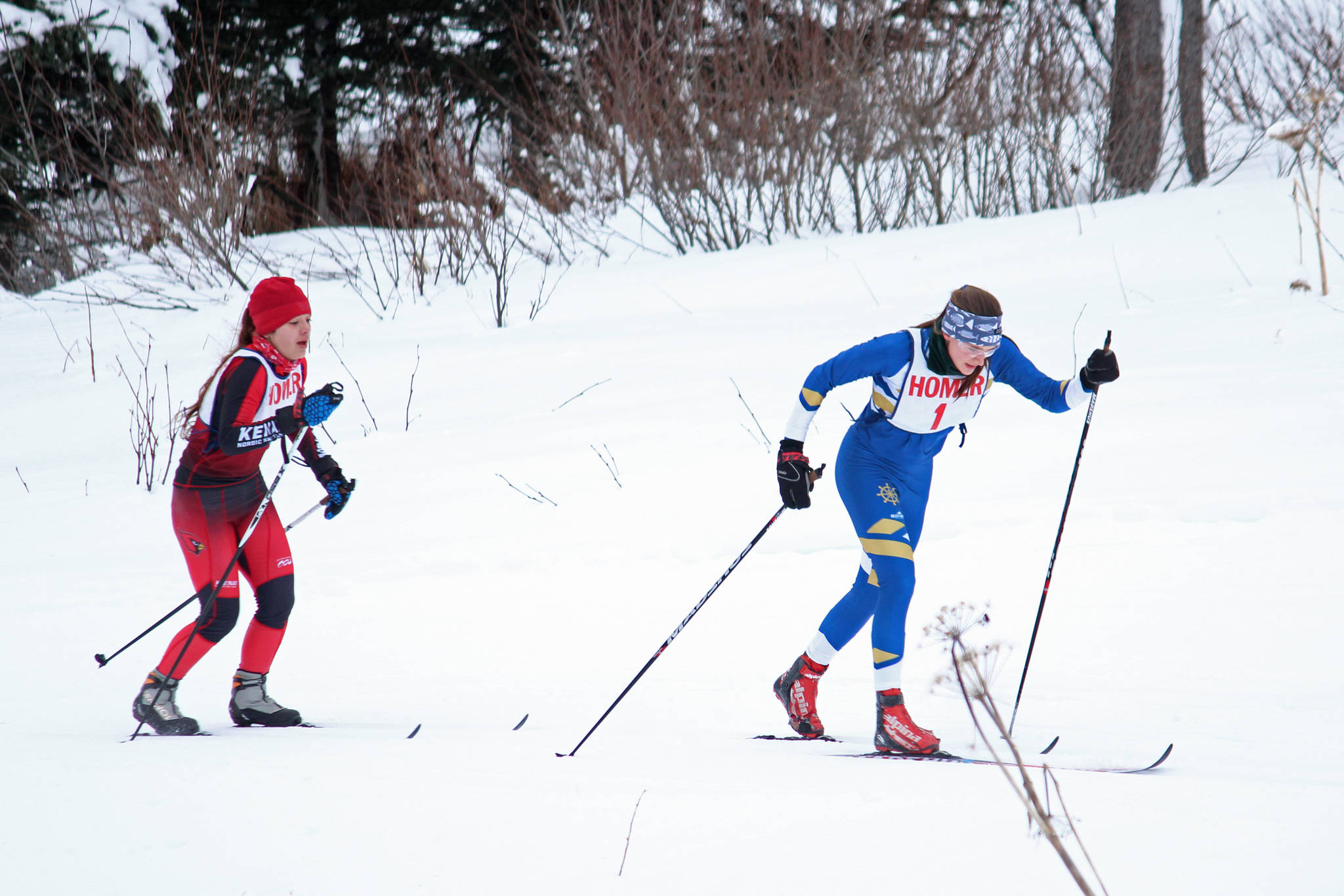 Homer’s Autumn Daigle pulls ahead of Kenai’s Maria Salzetti during the varsity girls’ classic cross-country ski race Friday, Feb. 1, 2019 at the Lookout Mountain Trails near Homer, Alaska. Salzetti had maintained the lead for the first portion of the race, and the two skiers battled for first throughout. (Photo by Megan Pacer/Homer News)