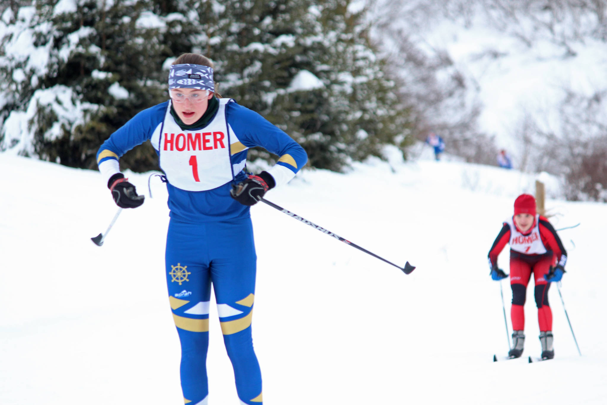 Homer’s Autumn Daigle skis to the finish line of the varsity girls’ classic race just ahead of Kenai’s Maria Salzetti on Friday, Feb. 1, 2019 at the Lookout Mountain Trails near Homer, Alaska. Daigle took first place. (Photo by Megan Pacer/Homer News)