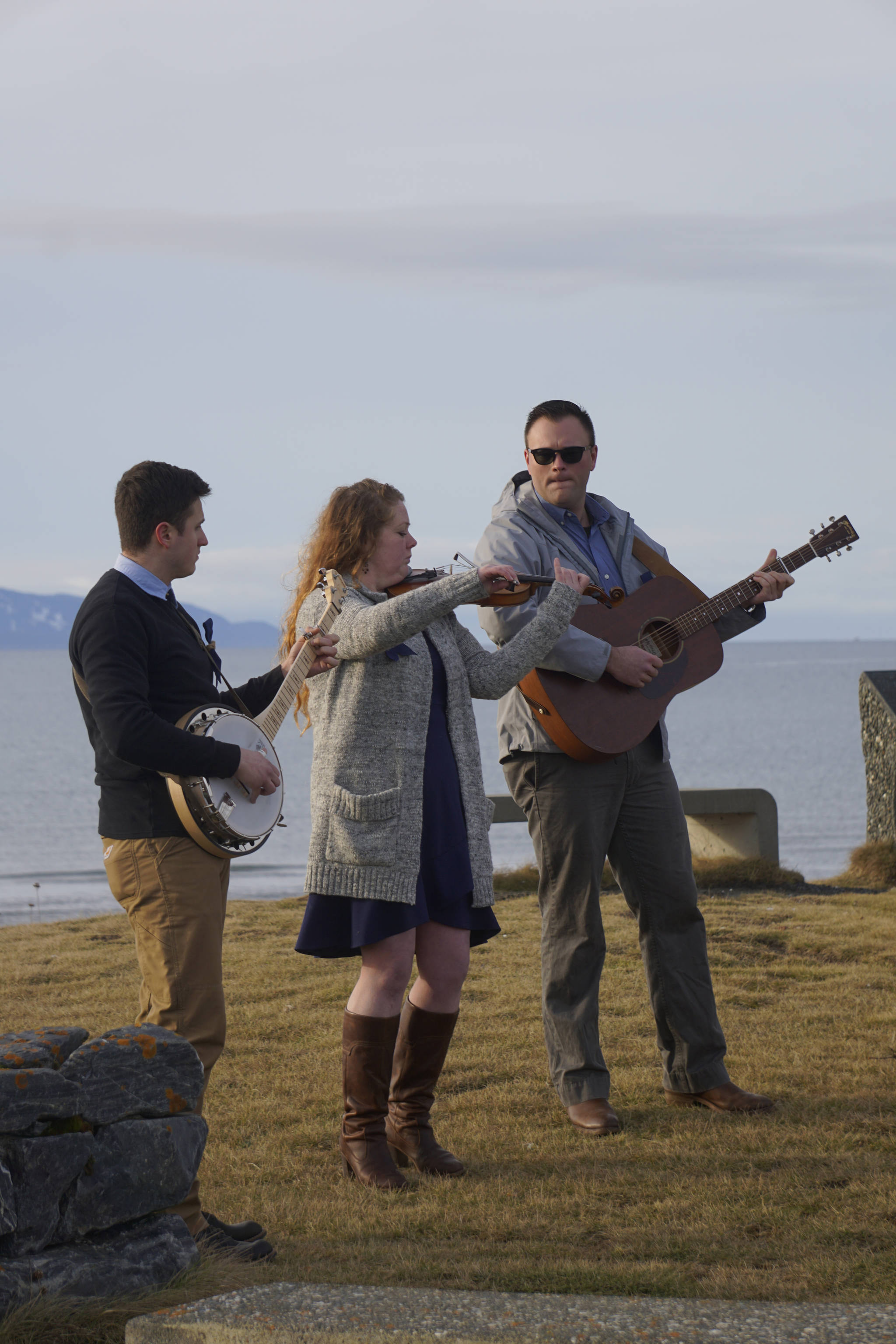 From left to right, Josh Kennedy, Kate Klann and Geddy Miller perform “I Bid You Goodbye” at a memorial service for Chief Warrant Officer Michael Kozloski on Friday morning, Feb. 8, 2019, at the Seafarer’s Memorial on the Homer Spit, Homer, Alaska. Kennedy served on the U.S. Coast Cutter Hickory with Kozloski and Miller is captain of the U.S. Coast Guard Cutter Naushon. (Photo by Michael Armstrong/Homer News)
