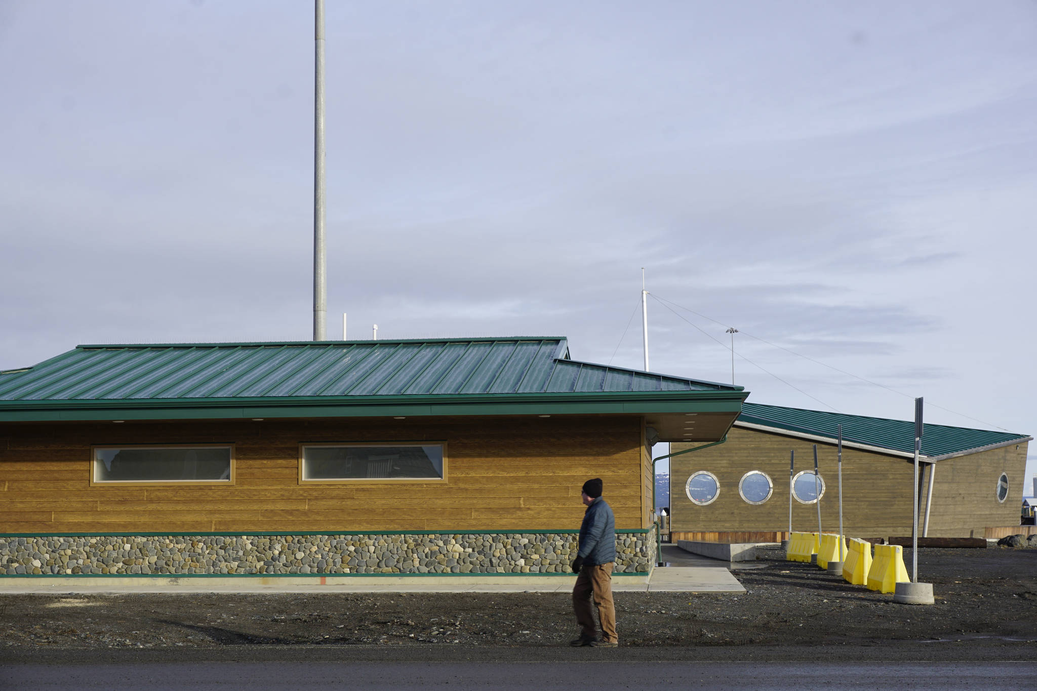 A man walks by the new Ramp 2 restrooms on the Homer Spit in Homer, Alaska, on Feb. 8, 2019. The restrooms opened on Feb. 2. (Photo by Michael Armstrong/Homer News)