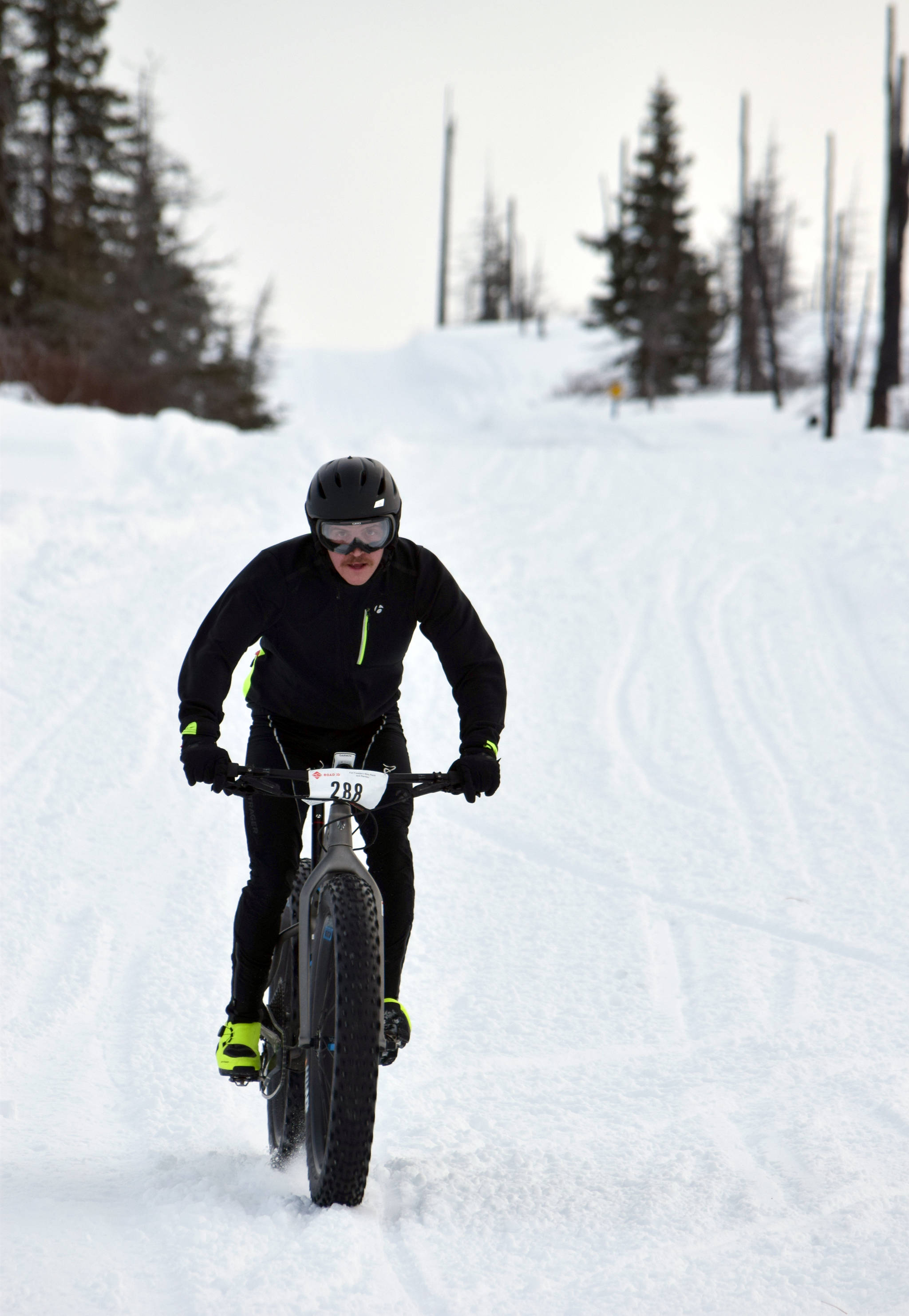 Mike Crawford barrels down a hill during Fat Freddie’s Bike Race and Ramble on Saturday, Feb. 9, 2019, in the Caribou Hills near Freddie’s Roadhouse. (Photo by Jeff Helminiak/Peninsula Clarion)